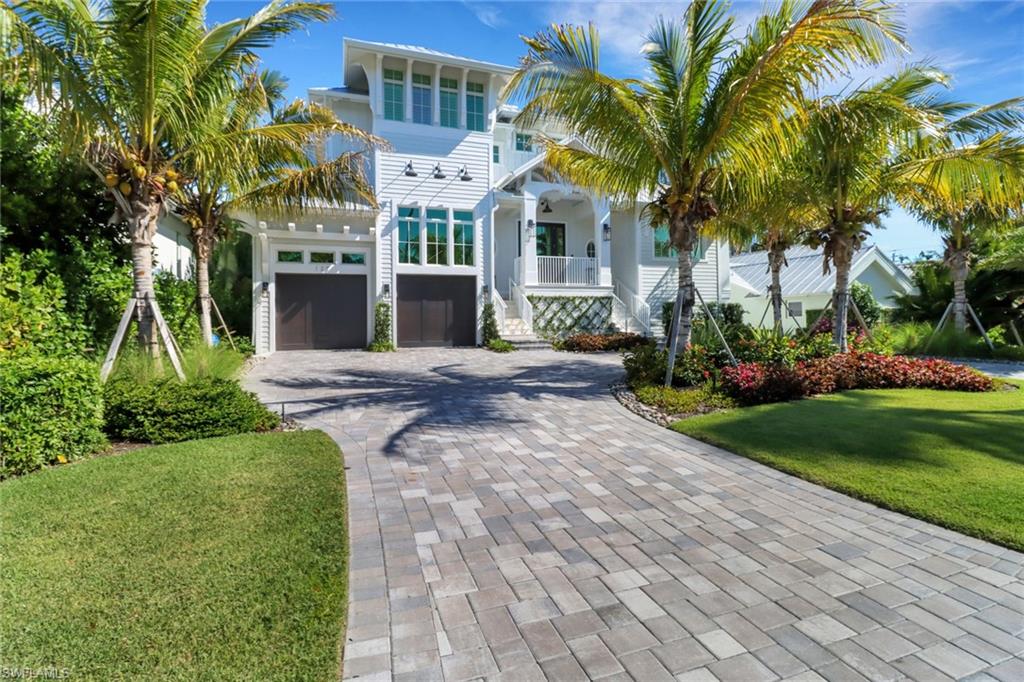 Welcome to a world of coastal contemporary elegance and exquisite architectural design. This masterpiece is a mere 138 steps away from the pristine beaches of the Gulf of Mexico, shopping and dining on 3rd St, this home is the epitome of luxury and sophistication. The expansive open floor plan seamlessly blends the great room, kitchen, and dining room, creating a lavish space to entertain guests. The gourmet kitchen is outfitted with the finest state-of-the-art appliances, including Wolf, Bertazzoni, and Miele, making it a culinary delight. The grand great room is warmed by a cozy gas fireplace, while the elegant dining room offers breathtaking views of the pool and spa. With five bedrooms and seven bathrooms, this home offers ample space for family and guests to relax. The opulent master suite is located on the first floor and features private access to the pool and spa, while the remaining four en-suite bedrooms are situated on the second floor. The backyard is a private oasis, complete with a shimmering pool, spa and lush tropical landscaping making it the perfect place to relax and unwind. This exquisite estate is a masterpiece of design and luxury built by Griffin Builders.