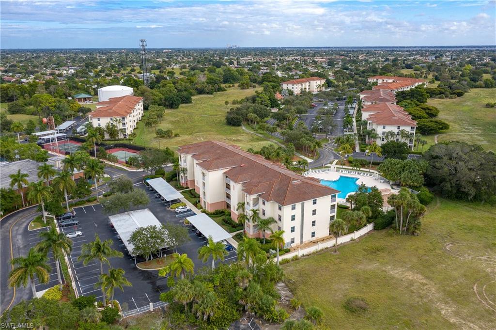 TURNKEY!!! 2 bedroom, 2 bath condo in a PET FRIENDLY (some restrictions) building of the gated Banyan Trace community. 2nd floor, rarely available END UNIT overlooking the resort style pool, spa, BBQ grills, and exercise room. Upgrades galore: Quartz/Corian countertops throughout. Porcelain/wood flooring throughout. Beautiful walk-in porcelain master shower with frameless glass door. Wet bar. New A/C. Plantation shutters throughout. Lanai has custom blinds. In-unit laundry. Walk in master closet. Ceiling fans in every room. Plenty of cabinet space. One covered parking space and loads of guest parking. Each condo has a storage closet just outside your door. Covered gazebo for community events/picnics, 2 spas, bocce ball, tennis, clubhouse/exercise building and a very lively community! Cable, high-speed internet, and water included in HOA fees.