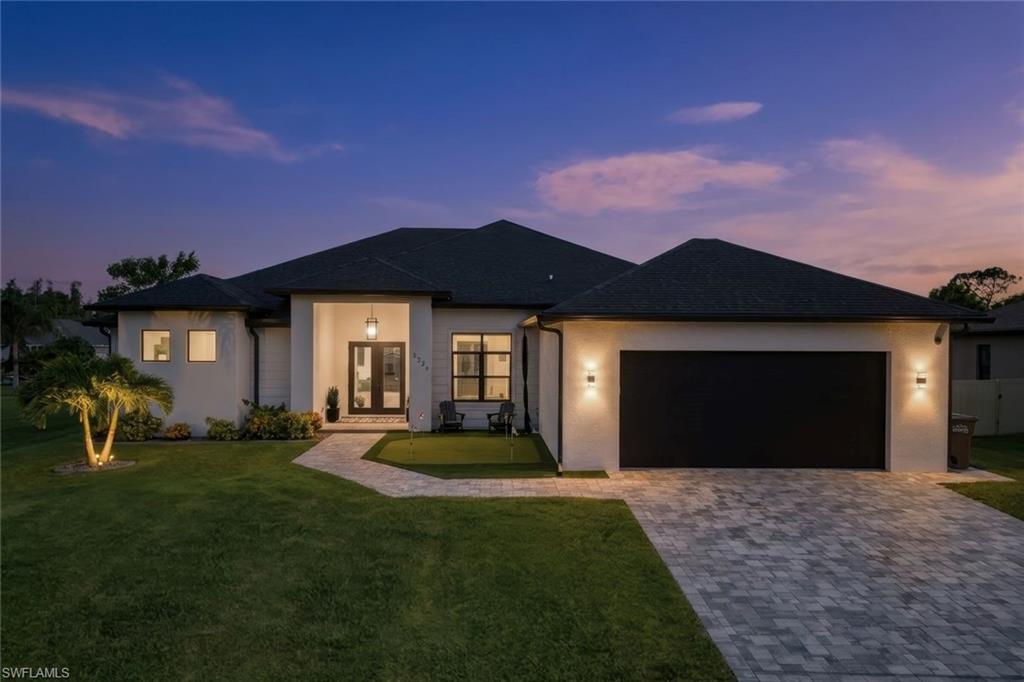 This custom-built Gulf access home offers 2,721 square feet of thoughtfully designed living space, featuring 4 bedrooms, 3 bathrooms, and a dedicated office. One of the guest bedrooms features its own en-suite bathroom, providing added privacy and flexibility for guests or multi-generational living.
Designed for both everyday living and entertaining, the home features 10-foot ceilings throughout, impact-resistant windows and doors, and an open-concept layout filled with natural light. The spacious kitchen showcases custom cabinetry, a large shiplap-accented island, a built-in bar area, a generous walk-in pantry, and a propane gas cooktop, creating the perfect gathering space for family and friends.
From the moment you arrive, a custom putting green at the front entry sets this home apart. The backyard is designed to embrace the Southwest Florida lifestyle with a custom heated pool and spa, an outdoor kitchen with a built-in propane BBQ, a built-in bar, and three in-water bar stools, creating the ultimate setting for entertaining or relaxing poolside.
Boating enthusiasts will appreciate the oversized Gulf access dock complete with a double captain's walk and a 10,000-pound boat lift, making it easy to spend the day on the water and return home to your own private waterfront retreat.
A spacious two-car garage completes the home, offering additional storage and convenience. Combining quality custom construction, flexible living spaces, exceptional outdoor amenities, and desirable Gulf access, this property offers a rare opportunity to enjoy luxury waterfront living in Southwest Florida.