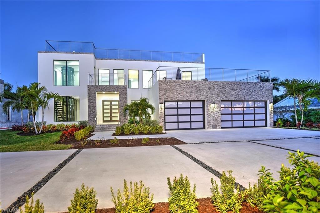 Must see!!! Brand new contemporary home with stunning sunset views from the rooftop deck. This 4 bedroom 6 and a half bath home is something special. The kitchen features Thermador appliances, including double wall oven, warming drawer and built in coffee maker. A beautiful island made from Cambria quartz, Nanoglass counter tops and  back splash made from crushed shells completes this custom kitchen. Open living room dining room concept, featuring a custom wine display glass case and a dual temperature wine fridge. Pocket sliding doors allow for indoor out door entertainment with access to the pool, spa, and grill. The pneumatic elevator takes you to your master suite, featuring a walk in closet and private balcony. The master bath features his and her vanities with crystal detailing, back lit mirrors, separate shower and a Japanese soaking tub. There are ensuite guest rooms located on the first and second floors, along with the laundry room. The three car garage offers plenty of room and storage possibilities. The home also features a roof top deck with hot tub, outdoor kitchen and roof top bath. Once you see the view from the top you will never want to leave!!!