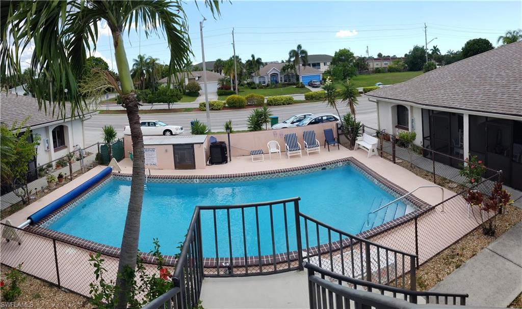 Looking good from up here. . . . .  This condo is the only 2nd story unit in the entire 8 unit complex.  Nothing like being front and center with the best view and enjoy the tropical breezes the 2nd floor has to offer.  All cleaned up and ready for occupancy. This unit shows well with it's custom plantation shutters on all windows, dome ceiling in the kitchen which has newer appliances and Formica counter tops.   Enter through the screened lanai and into the lovely airy feel and surrounded by Ceramic Tile throughout. New vanities in both bathrooms.  Master Bathroom has step in shower and guest bathroom has a tub/shower combo. Easy location in the Cape to get to and from where you need to be.  Small storage room on ground floor assigned to each owner.   ONLY 1 PARKING SPACE ASSIGNED PER UNIT.  This complex also has limited parking.  MUST BE 55 YRS OR OVER  to own or occupy this property.   NO PETS Perfect property for snow birds to retreat to each winter to get out of the snow!  HOA does allow 4 leases per year, with approval.