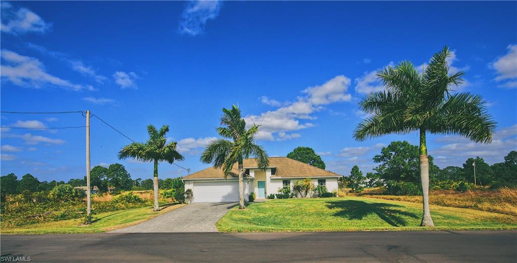 Welcome to your new tropical paradise! This home has it all. Professional landscaping w/ St. Augustine grass & sprinkler system. The large Palm Trees in the front yard adds curb appeal and makes this home stand out from the rest of the pack! Pull into your upgraded paver driveway that leads up to the inviting entryway. This 3 Bed 2 Bath Pool Home is sold “Turn-Key”! A spacious open floor plan featuring expansive vaulted ceilings in the living area and guest bedroom. A family dining area with a breakfast bar. Split-bedroom floor plan gives the master bedroom the privacy it deserves. The master bedroom has a walk-in closet & tray ceilings. Beautiful Spanish terra cotta tile flooring in the living area, bathrooms and laundry room. The laundry room is off the kitchen under air, so no more doing your laundry in the hot garage!  Gorgeous open kitchen that looks out over the living room. Dual sliding doors in the living area with one being a pocket slider. Open it up and have an indoor-outdoor tropical, resort-style feel right in your own home. Enjoy the in-ground pool and screened lanai area that overlooks the meticulously maintained yard!