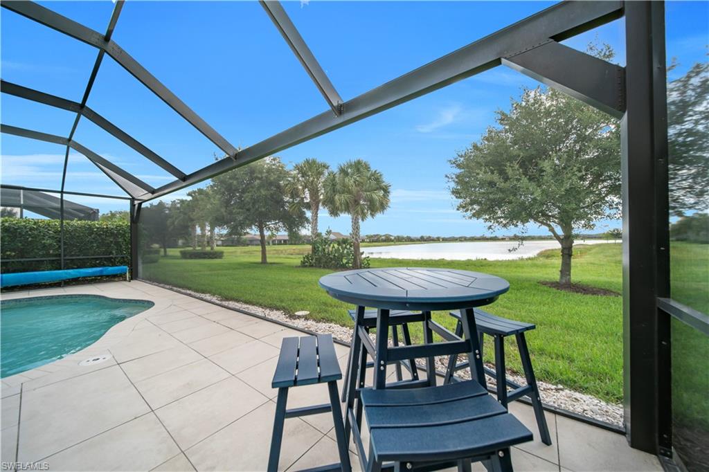 Some Homes Just Feel Different the Moment You Walk In.

There's something about 19408 Elston Way that stops you in your tracks, and it's not just the impeccable condition or the thoughtful Lennar Venice floor plan. It's the moment you pass through the great room and your eyes are drawn straight through the oversized picture window screen to the glittering lake beyond, the sun already beginning its slow, golden descent over the water.

This is the view you moved to Florida for.

Built in 2019 and lovingly maintained, this 3 bedroom, 3 full bath home offers 1,852 sq ft of bright, open living designed around that great room experience. The kitchen anchors the heart of the home with a breakfast bar, eat-in dining, pantry, and a full suite of appliances, all flowing effortlessly into the living and dining space so you're never far from the conversation or the view. And owned WATER FILTER under sink and SOFTENER.

But the real magic happens out back. Step through to your EXTENDED SCREENED LANAI and you are immediately greeted by the kind of scene that belongs on a postcard. A custom built in pool shimmering in the afternoon light, framed by a spacious patio and deck, with nothing but open water and painted skies stretching out before you. Sunsets here aren't just pretty. They're an event. The heated SALT POOL even has a solar cover to warm it up in the winter.

The primary suite is a true retreat, complete with dual sinks and a separate tub and shower. Two additional guest bedrooms, each with their own full bath, give family and visitors their own private space. An in-residence laundry room and 2-car garage keep the practical side of life effortlessly organized. With SOLAR panels to keep those electric bills low.

And then there's The Place at Corkscrew itself, one of Estero's premier gated communities where resort-style amenities are simply part of daily life. Spend your mornings at the fitness center, your afternoons on the pickleball or tennis courts, and your evenings at the on-site restaurant. With a resort pool and spa, bocce, volleyball, dog park, and more, every day here feels like a vacation you never have to leave.