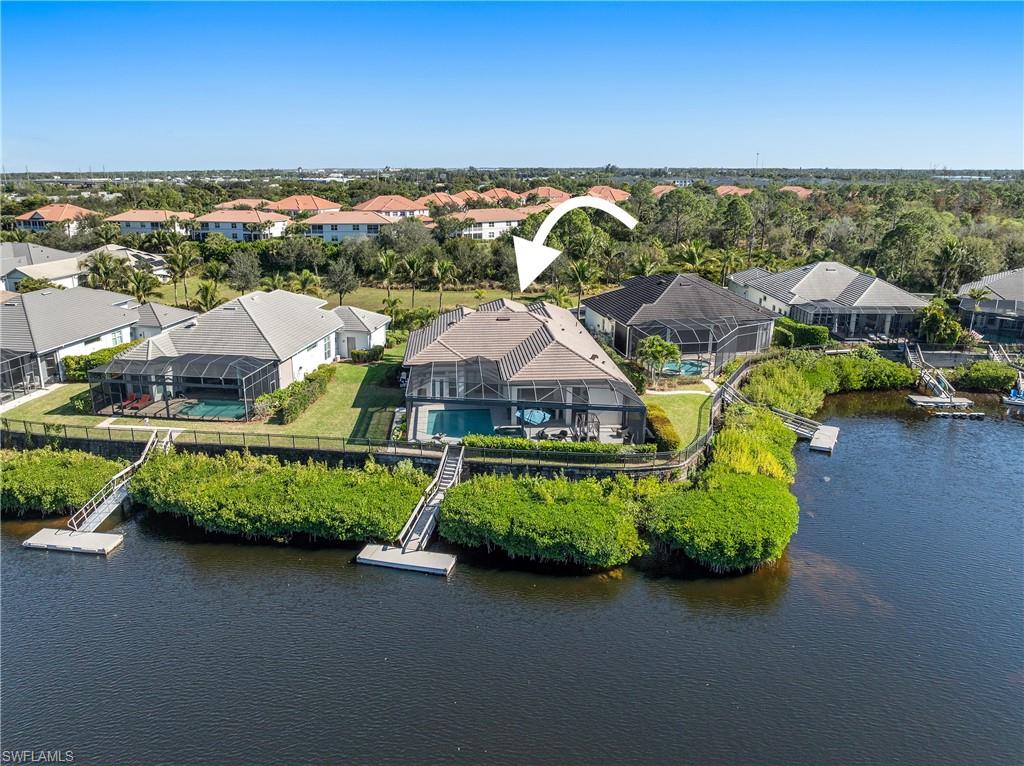 Offered for the first time, this exceptional Gulf-access turnkey residence is tucked within the gated enclave of Hidden Harbor, one of Southwest Florida's best-kept secrets. Situated on a rare peninsula homesite with a deep setback, the property enjoys enhanced privacy, no home directly in front, and a tranquil backdrop overlooking the community's expansive harbor. Perfectly positioned on a premium southern-exposure lot, the residence captures spectacular sunset views, frequent manatee sightings, abundant fishing opportunities, and direct boating access to the Gulf of Mexico from your private dock via the Ten Mile Canal, Mullock Creek, and Estero Bay. Designed for both everyday living and grand-scale entertaining, the residence offers 4 bedrooms plus a den, 3.5 baths, and a thoughtfully designed floor plan that seamlessly connects indoor/outdoor living spaces. Hurricane-rated windows and doors provide peace of mind, while the home's elevated construction (built up 3 additional feet) remained dry inside during Hurricane Ian. The interior showcases a bright, open-concept design highlighted by oversized porcelain tile, wood-look flooring in select spaces, a spacious great room anchored by a built-in 98-inch television, and a beautifully appointed kitchen centered around an expansive island. The layout includes a luxurious primary king suite and a generously sized junior guest suite featuring its own king bed, creating dual-suite accommodations ideal for hosting guests, extended family, or multi-generational living while ensuring comfort and privacy for all. Outdoor living takes center stage. The extended screened lanai was designed to embrace Southwest Florida's year-round lifestyle, featuring a 450 square foot resort-style pool, raised spa, upgraded travertine 16x16 pavered decking, outdoor ceiling fan, fire pit stub-out, and a fully equipped outdoor kitchen complete with a separate island and bar seating area. Beyond the lanai, a private dock provides immediate access to the harbor and serves as the perfect launching point for boating, kayaking, fishing, or simply enjoying the tranquil waterfront setting. Additional highlights include an EV charging outlet in garage, extra dryer and dryer hookup in the garage, an air-conditioned storage room, multiple televisions that convey with the home, and a kayak with paddles. Residents of Hidden Harbor enjoy access to an exclusive waterfront clubhouse featuring a social room, fitness center, lap pool, and kayak launch area. Ideally located near I-75, Gulf Coast Town Center, Miromar Outlets, Florida Gulf Coast University, RSW International Airport, dining, shopping, and professional sports venues, this residence offers a rare combination of luxury, privacy, boating access, and convenience. Whether seeking a year-round residence, seasonal retreat, investment opportunity, or an entertainer's dream home, this remarkable waterfront property delivers a lifestyle few communities can match.