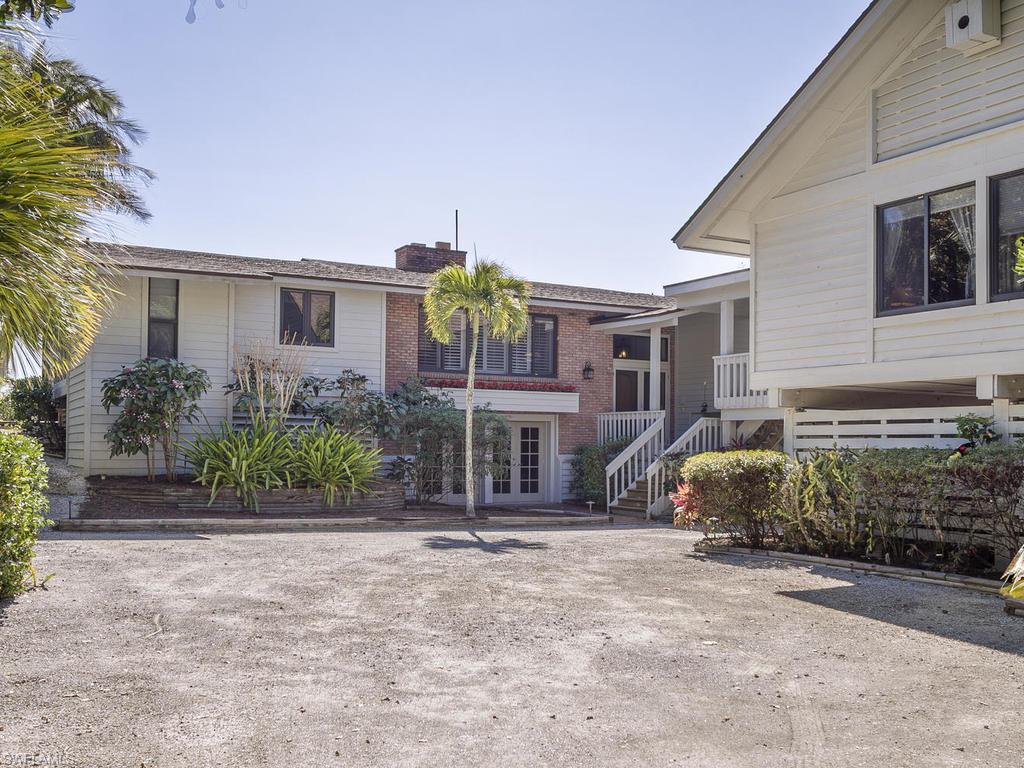 Crafted with poured concrete construction and built in the "Island Cottage" tradition, this 5BR/4.5BA home features a new Chef's kitchen w/top of the line stainless appliances, 2 fireplaces, wood floors, new doors/impact windows, swimming pool, welcoming sunny vistas and privately landscaped grounds. The main house was thoughtfully designed; most primary rooms are directly Gulf front. The Guest house is separated from the main house by a covered walkway and contains 2 spacious bedrooms. The entire home has been renovated and offers open spaces, a private picnic area on the Gulf side of the home to enjoy the pristine beaches and private grounds. Meticulously maintained and loved for 35 years!, located on West Gulf Drive, this property offers the ultimate dream location!