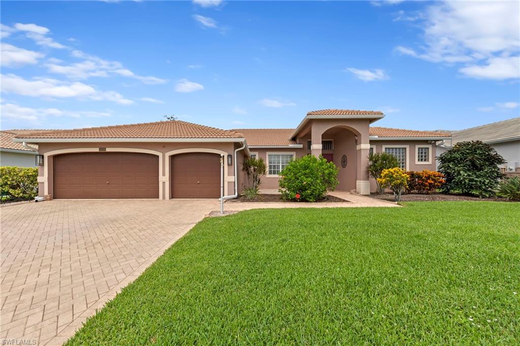 Enjoy incredible wide and long lake views from this beautifully updated 3 bedroom, 2 bath pool home in the gated community of Waterways of Naples. Offering nearly 1,900 square feet of living space, this residence makes a memorable first impression with its paver driveway, rare 3 car garage, and double door entry opening to a bright interior finished with tile flooring throughout. At the heart of the home, an upgraded kitchen showcases rich brown cabinetry, stainless steel appliances, and granite countertops. A beautifully appointed primary bath elevates the owner's suite, complete with a large glass-enclosed shower, a soaking tub, and two separate vanities. Two additional bedrooms offer comfortable accommodations for family and guests. Beyond the living areas, a resurfaced pool overlooks the expansive lake, creating a serene setting for both quiet mornings and lively gatherings, while electric shutters on the lanai deliver effortless storm protection. A newer roof provides added value and lasting peace of mind. Residents of Waterways of Naples enjoy an impressive collection of amenities, including a clubhouse, community pool, fitness center, fishing pier, pickleball, tennis, basketball, volleyball, a play area, and a tiki hut picnic area, all within a welcoming gated setting convenient to shopping, dining, and everything Naples has to offer.