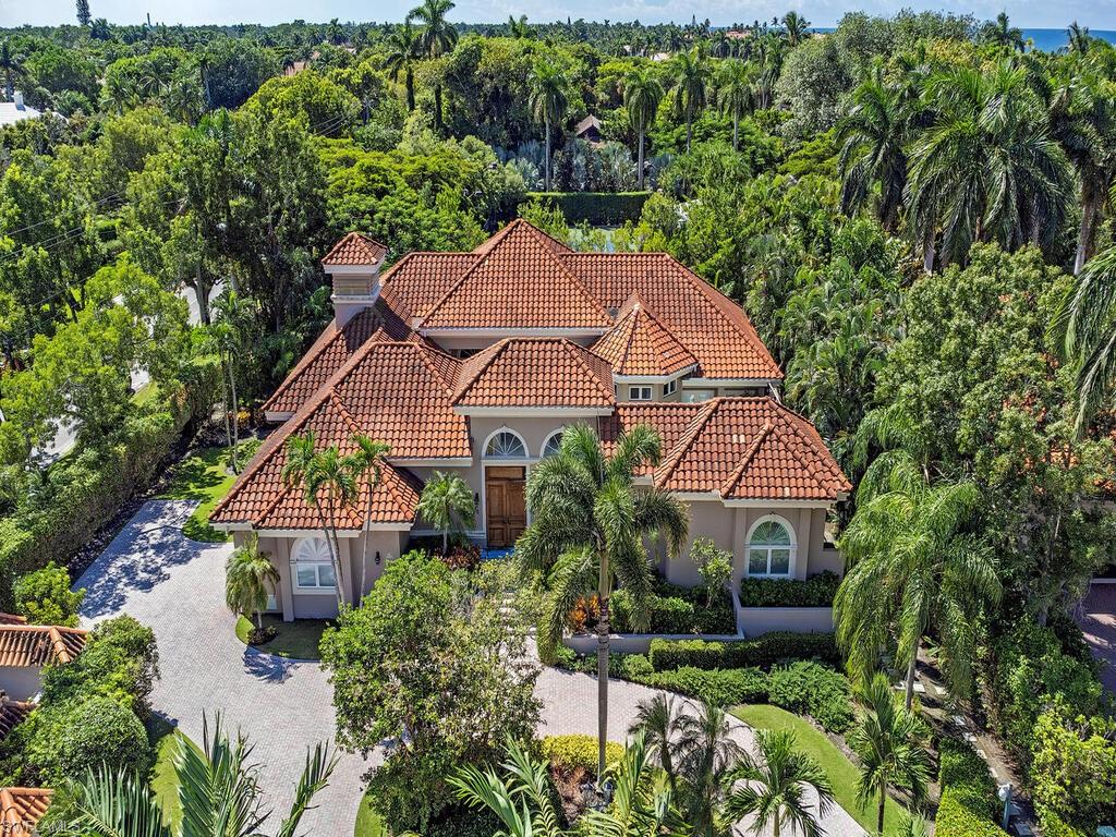 In the private, gated enclave of Gordon Drive Estates a mere three doors from the sugar sand coastline, lies this meticulously maintained, custom home enveloped by lush, tropical foliage. The entire residence is defined by volume ceilings, as well as large sliders and transom windows that allow natural light to pour in and create a warm, comfortable ambiance. The floor plan flows through 3,033 sq. ft. of living space - all culminating in the spacious atrium that is perfect for entertaining. The kitchen is open to the family room and features two center islands, granite countertops, Viking appliances, a pantry, and custom cabinetry. Secluded and offering the utmost in privacy, the master suite is sprawling and is accompanied by a luxurious bath with Carrera marble flooring, a soaking tub that is flanked by a fireplace, and spacious walk-in shower. The home also encompasses a charming second bedroom with private bath, a cabana guest suite with private entrance, and a study. Gordon Drive Estates offers tranquility and luxury with its resident-only gated beach access, as well as enjoys the convenience of being located within seconds to the renowned shopping and dining found on Third Street South. Additionally desirable and worth note is that this home did not receive any interior water intrusion during recent storms, including Ian.