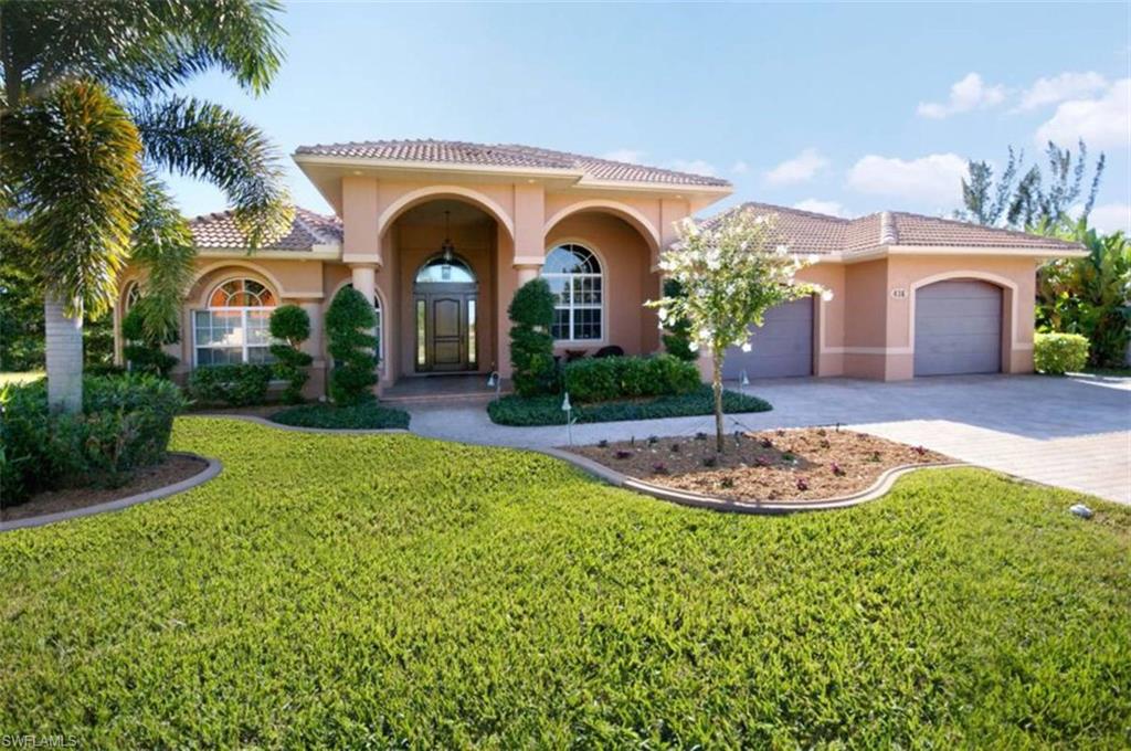 Exquisite Gulf access home for the discriminating buyer w/privacy & comfort in mind. Great thought went into designing this custom home; beautiful volume tray ceilings, tile in the living/wet areas, crown molding, exercise room w/mirrored wall & half bath; large gourmet kitchen overlooking the pool/great room & features an island work-station, wood cabinets, solid surface counter tops & MORE! Home has a laundry room w/plenty of storage cabinets, room for hobbies/crafts of all kinds. Garage has attic lift elevator for additional storage as well. Decorative columns lend a subtle separation between rooms. Cove lit vaulted tray ceilings add ambiance. Entertaining on the large patio w/summer kitchen is comfortable and easy. French doors lead to the outdoor living area featuring salt water pool, rock waterfall, swim up tiki bar & stools surrounded by tropical plants w/spa & plenty of room for relaxing in the sunshine. Captain's walk has 10,000 lb. lift, water & electric ready to accommodate all your boating pleasures. Don't miss this exceptional home w/3,349 square feet under air in perfect condition with all the bells & whistles! The vacant lot is also for sale MLS#217016322.