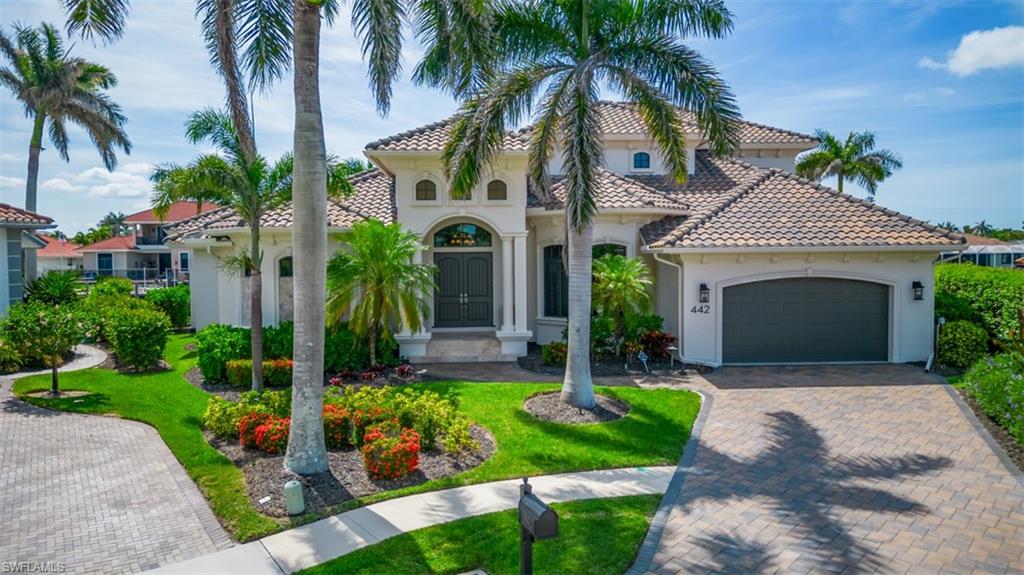 Introducing 442 Balsam Court, an amazing 4-bedroom, 4.5-bath direct access home with southern exposure, offering everything you desire in the coveted location of Marco Island, Florida. Meticulously constructed by the award-winning R.K. Reiman Construction, this home showcases the builder's unwavering attention to detail at every turn. Step inside and experience the seamless flow of the large great room floor plan, where the spacious kitchen, complete with a sizable island, walk-in pantry, and wet bar with a wine room, invites culinary creativity and social gatherings. The expansive covered lanai beckons you outdoors, revealing an outdoor kitchen and bar, a cozy fireplace, automatic hidden hurricane shutters, a generously-sized pool with a spa, and an ample pool deck for basking in the sun all day. Noteworthy features include tankless water heaters, a Generac Generator, an oversized garage, tongue and groove outdoor ceilings, surround sound, fresh paint, propane tank, large dock with 14,000 LB lift, stone pool deck, linear fireplace, and much more. This home looks brand new, and is being sold fully furnished, providing an effortless transition into a luxurious coastal lifestyle.