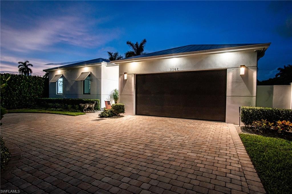 Exceptional craftsmanship, timeless design, and uncompromising quality define this one-of-a-kind custom residence. From the moment you step inside, the striking contemporary architecture, dramatic covered entry, and custom double doors set the tone for a home where every detail has been thoughtfully curated. Built to an exceptional standard, this residence showcases a level of quality and attention to detail rarely found in today's market. Inside, soaring ceilings and stunning stained tongue-and-groove wood ceilings with architectural recessed LED lighting create a warm yet sophisticated atmosphere throughout the main living areas, primary suite, and covered lanai. Expansive casement windows, solid-core doors, custom millwork, and large-format porcelain tile flooring reflect craftsmanship more commonly found in Naples' premier luxury homes. Designed for effortless entertaining, the open floor plan blends indoor and outdoor living through expansive sliding glass doors spanning the rear of the home. The chef's kitchen features sleek custom cabinetry, quartz countertops, an oversized island, premium appliances, gas cooktop, built-in wine refrigerator, designer tile backsplash, and abundant workspace. The resort-inspired lanai features matching tongue-and-groove wood ceilings, an outdoor kitchen, propane firepit table, multiple seating areas, and overlooks the sparkling saltwater pool and spa. At night, professionally designed architectural and landscape lighting transform the property into a breathtaking private retreat. The luxurious primary suite offers direct lanai access, matching tongue-and-groove wood ceiling, and a spa-inspired bath with a freestanding soaking tub, oversized walk-in shower, dual vanities, and designer finishes. The split-bedroom floor plan provides exceptional privacy, while the third bedroom features a Murphy bed, allowing it to function beautifully as a guest suite or executive home office. Luxury extends well beyond what you can see. Control4 whole-home automation, Lutron motorized shades, impact-resistant windows and doors, whole-house generator, and a buried 500-gallon propane tank, also serving the gas cooktop in the kitchen, provide exceptional comfort, convenience, and peace of mind. Towering Calusa hedges surround the fully fenced backyard, creating an extraordinary level of privacy. With more than $350,000 in thoughtfully selected upgrades beyond comparable homes, this residence delivers a level of quality and craftsmanship that can only be fully appreciated in person. Ideally located just minutes from Naples' white-sand beaches, downtown, 5th Avenue South, exceptional dining, shopping, and entertainment. A comprehensive Features & Upgrades List is available for review during showings.