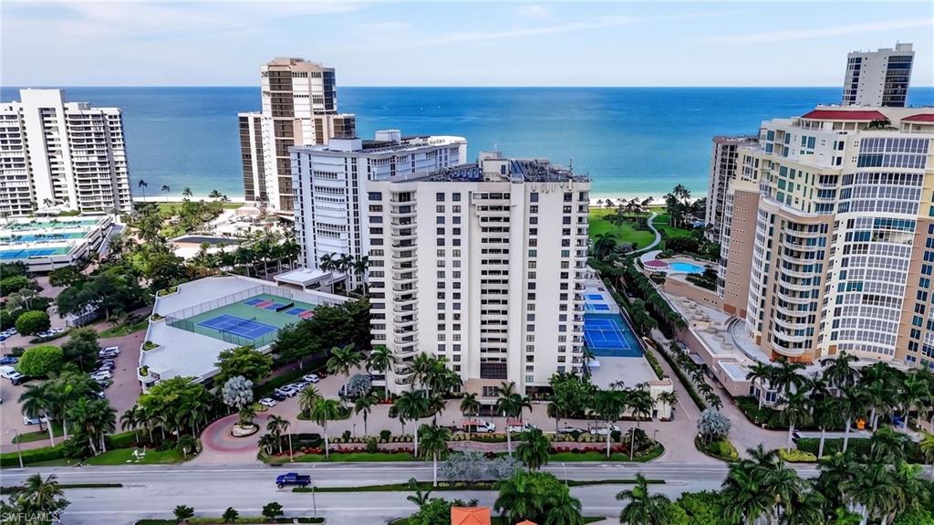 Live above it all in Residence 1604 at Solamar — a beautifully furnished 3 bedroom retreat offering 2,250 square feet of high-floor coastal living in the heart of Park Shore, Naples. This condo pairs high-end designer furnishings with an updated kitchen and renovated baths, so you will feel like you are at a luxury hotel – complete with a soaring open air atrium lobby and beautiful water feature.
Sixteen floors up, the views do the talking — sweeping vistas of the Gulf of America, Venetian Bay, and the Naples skyline, with golden sunrises over the bay and brilliant sunsets over the water from your private balconies. The open layout flows from a light-filled living room — complete with a comfortable sofa bed for guests — into a spacious updated kitchen and dining area built for both easy mornings and effortless entertaining.
Both bedroom suites are designed as private getaways. The primary is your private retreat, with two spacious walk-in closets and a large bathroom.  The third bedroom makes an ideal home office, workout room, or extra space for visitors with a comfortable sofa bed. With 2,250 square feet under air, there's room for everyone to spread out and relax.
Residents of Solamar enjoy a true resort lifestyle: a 24-hour doorman, full-time security staff, and a recently renovated beachfront pool and spa with sundeck. Stay active with a state-of-the-art fitness center and sauna, tennis, pickleball, and shuffleboard, then gather at the grilling pavilion or one of the building's elegant social lounges. Paddle board storage, beach chairs for residents, secure under-building garage parking, and ample guest parking complete the package. Expecting extra guests? The in-building guest suites are available at a nominal fee.
Step outside and you're directly on the Park Shore promenade — a private 1.3-mile paved path tracing the beach. Walk to the Village on Venetian Bay for waterfront dining and boutique shopping, and for boating enthusiasts, boat slip leasing and rentals are available at the marina just across the street.
This is Naples beachfront living at its finest — fully furnished, impeccably maintained, and ready to enjoy from day one. Schedule your private showing of Residence 1604 today.