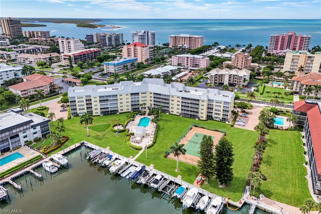 Exquisitely remodeled and offered furnished, this spacious two-bedroom, two-bath waterfront residence enjoys coveted direct Gulf access and a prime south-end Marco Island location just moments from beach access. Thoughtfully redesigned with exceptional attention to detail, the open-concept kitchen showcases granite countertops, a striking glass tile backsplash, custom cabinetry, stainless steel appliances, and a convenient stacked washer and dryer.  Impact-resistant sliding glass doors and windows are complemented by elegant Hunter Douglas plantation shutters, while timeless tile flooring flows throughout the residence, creating a sophisticated, low-maintenance living environment.  The desirable first-floor setting provides seamless indoor-outdoor living, with direct access from your private lanai to the resort-style amenities, including the pool, spa, gas grilling area, and marina docks. Boating enthusiasts will appreciate the direct water access and accommodations for up to a 30-foot vessel. Dock leases are available through the Association, subject to availability.  Ideally situated near Marco Island’s premier dining, boutique shopping, and entertainment venues, this exceptional waterfront retreat offers the perfect blend of luxury, convenience, and the ultimate coastal lifestyle.