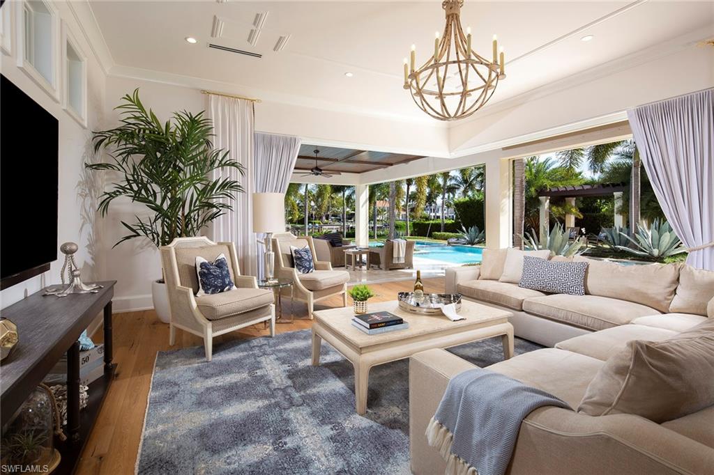 Perfectly situated on Runaway Bay, this West Indies gem is the ideal Port Royal estate. Encompassing over 7,600 square feet with five bedrooms plus a den, no amenity is left to be desired. Luxurious oak floors lay the perfect framework for the neutral palette of fine wallpaper designs and custom millwork to create an elegant yet comfortable experience. The gourmet kitchen opens seamlessly to the family room and covered veranda beyond offering the best in entertaining. The resort like outdoor space is paradise found, featuring two pool areas and spacious spa all surrounded by terraced grass and uncovered and covered patio space. This one of a kind residence is also eligible for immediate Port Royal membership.