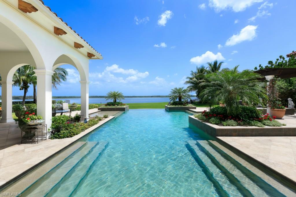 A truly exceptional opportunity to own one of only 7 properties in the exclusive Castelli enclave. Located on Lake Maggiorie with stunning water views, this custom, 1-story, Toscana Home is nestled on one of the largest homesites w/ an expansive backyard. Tremendously private, yet walking distance to the world class amenities of Miromar Lakes Beach & Golf Club, voted #1 in the US for its extraordinary resort lifestyle. Renovated this year with totally new kitchen featuring white Brookhaven cabinets, gleaming white quartz countertops, two center islands, a bay window, Wolf & SubZero appliances, butlers pantry & china closet. Florida Elegance describes this home with its mahogany doors, high barrel vault ceilings and expansive window views of the lake and pool. The richness of the recently installed Brazilian Walnut floors provides a pleasant contrast to the flood of light streaming in the many windows. A comfortable Ralph Lauren style family room invites casual entertaining w/ an expansive covered lanai & breathtaking 50’ pool w/ disappearing edge, water feature & spa, outdoor kitchen, fireplace & guest cabana. Four renovated baths include his & hers baths and closets in the master.