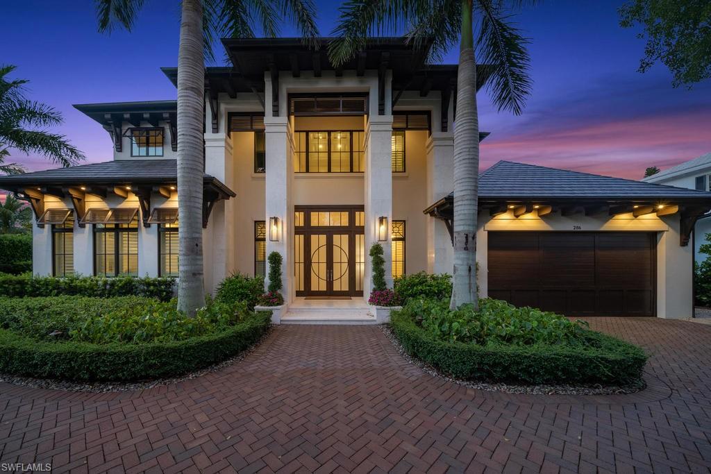 Discover the meaning of luxury living in the heart of Old Naples. This stunning residence, steps from the sugar sand beach, offers an impressive level of finish and design. Completed in 2017, the home merges both an open and formal concept with wide plank wood floors, custom trim work, and many other refined custom interior features. The custom kitchen built for entertaining includes Sub-Zero, Wolf and Miele appliances, and a large custom island. The wine room defines casual elegance and is sure to impress any guest.  An oversized family room and formal dining space look out to a sublime tropical retreat that features a large pool and spa. The outdoor living area includes hidden motorized screens, a summer kitchen, and an open-air dining area. The main level master suite has two oversized walk-in closets with custom cabinetry, a sitting area with a private spa view, a spacious master bath with custom cabinetry and natural stone. On the second level, all three of the suite-sized guest rooms have en-suite bathrooms and walk-in closets. Located on one of the most beautiful streets in Old Naples, and just a short stroll from the renowned 5th Avenue South, this home is a must see!
