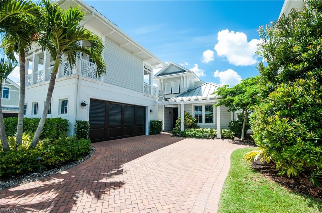 Custom built residence with Old Florida charm!  Southern exposure and spectacular unobstructed water front views with covered boat slip included.  The main single story living area offers superb interior finishes with 3 en-suite bedrooms plus a powder bath.  A separate guest suite is located above the garage with a private entrance. Features include Crestron lighting system, Bella Citta wide blank wood floors, cathedral ceilings, wood shutters in main living area, pocket sliders and electric roll down screens on the patio. The kitchen features a Wolf cook top with natural gas, Sub-Zero refrigerator/freezer, custom Ruffino cabinets, center island, and wine bar with included wine refrigerator.  Enjoy the views of your pool, spa and all of the outdoor waterfront beauty.