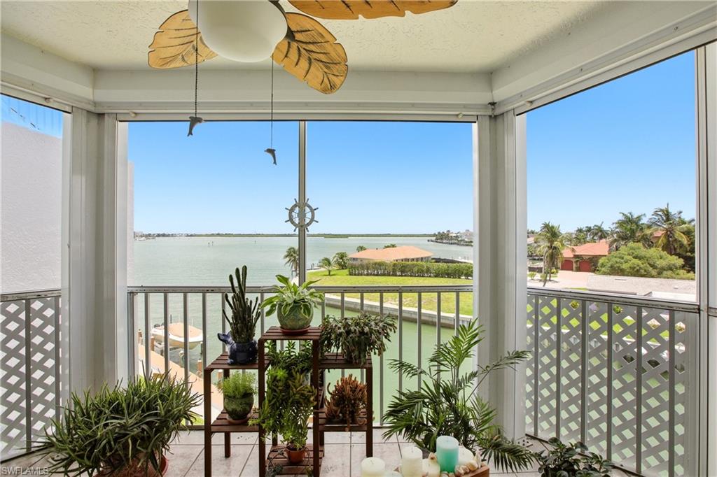 Experience Paradise here at Grand Bay! It is rare that one of the top floor units become available. This beautifully decorated condo breathes coastal life at it finest; and the stunning wide-water views of the Big Marco River will mesmerize you every single day. Whether you are sipping your morning coffee or your favorite cocktail on the lanai, you will enjoy the sunrises and moonrises as the light beams carry across the water! You will never tire of watching the dolphins playing in the water as well as a variety of species of wild life. The boat activity is second to none! The cleanliness of this complex will be one of the first things you notice when you step on site. The assigned parking carport, #26, is right beside the elevator! Assigned storage is D15 and it is climate controlled. You are permitted one pet that is 20 pounds or less. Grand Bay is within walking distance to boat and bike rentals and to the World Famous Snook Inn--Waterfront Dining, The Dolphin Tiki and many other restaurants and shops. Rose Marina, is approximately a half a mile away, this marina is the launch site for the Key West Express and they offer boat rentals as well. This is Southwest Florida living at its finest!