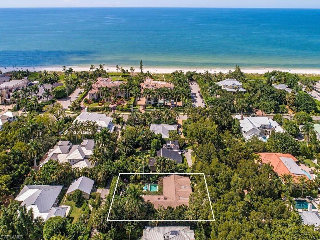 H3564 - This Old Naples Cottage home is a perfect union of style and function and is situated just three doors to the beach on a large 100’ x 150’ lot. This large lot has southern exposure and an open patio with heated salt-water pool, bougainvillea covered latticework and lush environs. As you enter you are greeted by beautiful tongue and groove cathedral ceilings, custom millwork, vintage pendant lighting and vertical wood plank accent walls to complete the cottage look. Additionally, this home features vintage terrazzo and tile flooring, custom cabinetry and lighting, updated bathrooms, skylights and open, flowing floorplan. The kitchen has been updated to please the chef of the household with a Viking gas-range, beautiful cabinetry, Sub-Zero refrigerator and freezer drawers, abundant counters and large breakfast bar. The expansive master suite has a 13.3’ x 13.6’ sitting room, updated bath, walk-in closet and pool walk-out.