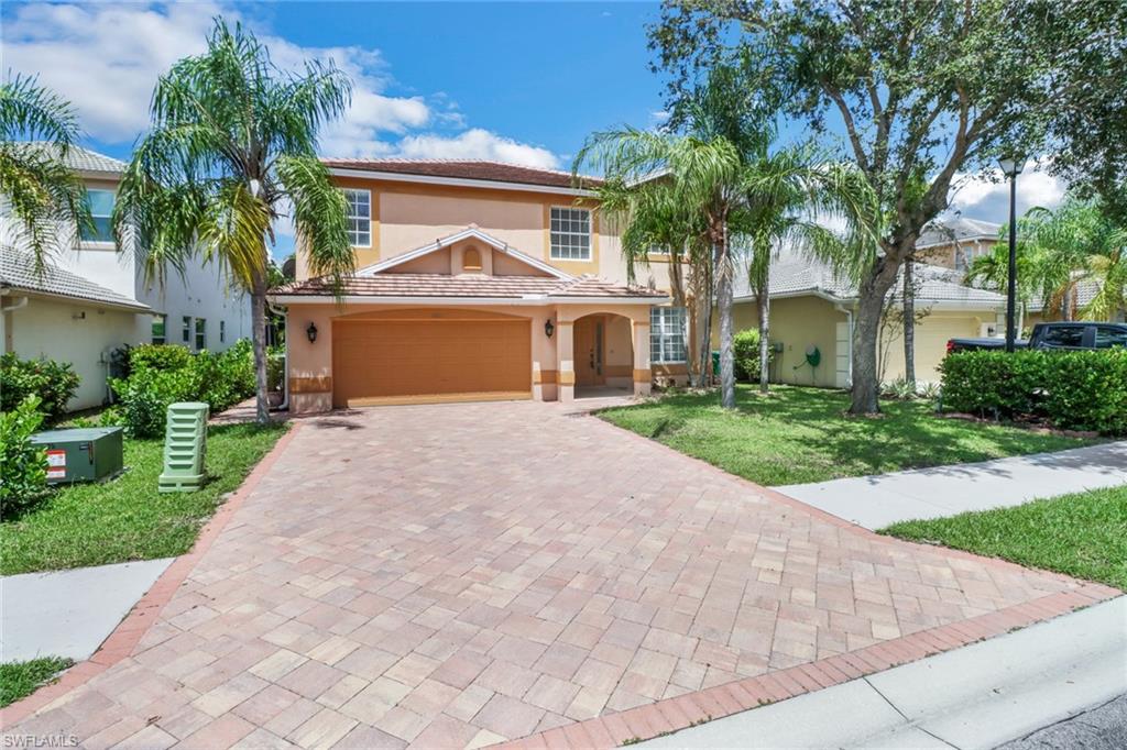 One or more photo(s) has been virtually staged, AI generated or rendered.  POOL HOME | AVAILABLE NOW (w/ assoc. approval) | TOP NORTH NAPLES SCHOOLS | Beautifully remodeled 4-bedroom pool home in the gated community of Laurel Lakes. Recent big-ticket updates — roof, kitchen, and HVAC (all 2021) — plus a Tesla charger in the garage. The remodeled kitchen features high-end stainless appliances (wall oven, range, refrigerator), modern wood cabinetry, granite counters, and a designer tile backsplash. Expansive tile-floored living areas open to a screened lanai built for Florida living: heated pool with pool care included by owner, plus a full outdoor kitchen for entertaining. Upstairs are four spacious bedrooms — each fits a king — finished in easy-care luxury vinyl plank. The oversized primary suite includes a large seating area (ideal home office or media room) and a spa-style bath with dual vanities, soaking tub, and glass-enclosed shower. Laurel Lakes offers a community pool, tennis, and basketball courts, and sits minutes from Logan Landings and Founders Square dining, I-75, and the white-sand beaches of Delnor-Wiggins State Park.