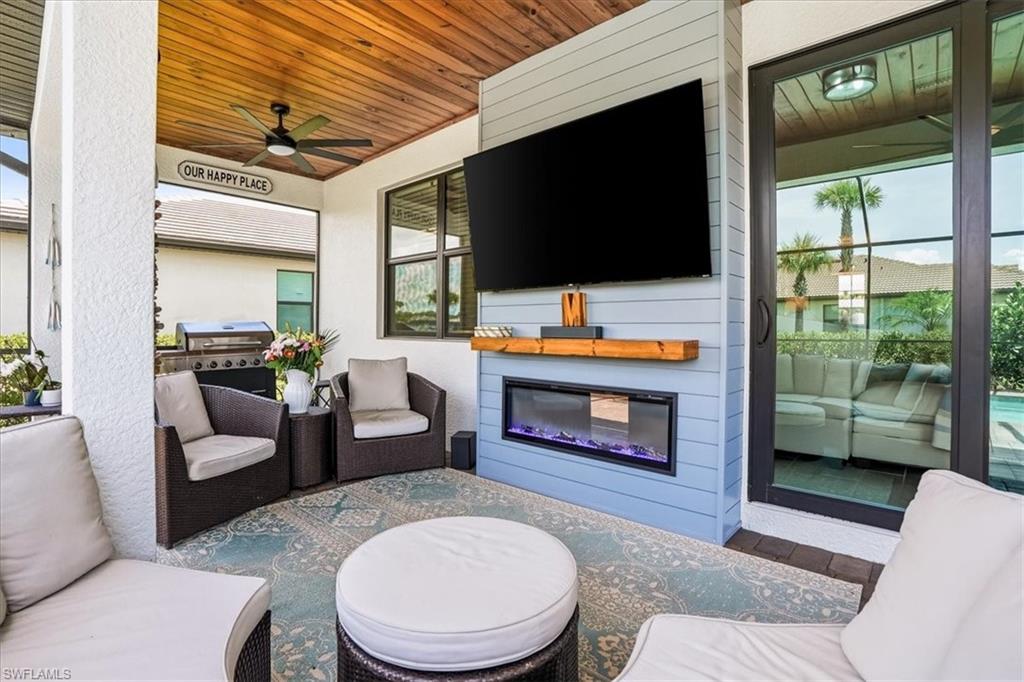 Tucked into the vibrant Verdana Village community, this exquisitely upgraded Amalfi model at 18656 Ives Drive proves you don't have to wait to build to own something truly special. With 4 bedrooms, a versatile upstairs loft, 3 full baths, and 2,606 square feet of impeccably finished living space, every inch tells a story of thoughtful craftsmanship. The current owners spared no detail. Custom wood-detail walls grace the entry, dining room, office, loft, and primary suite, while crown molding wraps the entire first floor. A striking entertainment build-out anchors the main living room with floating shelves and a fireplace, echoed by a second feature wall in the loft. The kitchen impresses with a gas range, quartz counters, abundant cabinetry, custom backsplash, and a shiplap-wrapped island, complemented by a stylish coffee bar with wine fridge. Carpet has been eliminated throughout—including the staircase—and matte black hardware ties the palette together. Just outside is a fully enclosed pool and spa retreat featuring color-changing LEDs, a tongue-and-groove wood lanai ceiling, and a custom outdoor fireplace built for evening gatherings. Fresh exterior paint, upgraded lighting, sealed pavers, and lush new landscaping complete the picture. Impact glass windows deliver peace of mind through any storm. Three bedrooms reside upstairs alongside the loft, while a fourth bedroom on the main level offers flexibility for guests. The location is equally compelling. Publix at The Shoppes at Verdana Village sits less than a mile away, with Miromar Outlets, Gulf Coast Town Center and Southwest Florida International Airport within a short drive. Residents enjoy a remarkable amenity center boasting an indoor sports complex with tennis, pickleball, and basketball, plus a fitness center and resort-style pool. This is move-in-ready Estero living, elevated by uncommon quality and finished with genuine care.