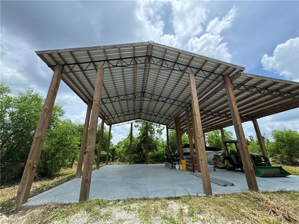 BUILD YOUR DREAM HOME IN A NO FLOOD ZONE. Located in Bokeelia on Pine Island Ridge. This fenced and gated property has a large structurally engineered pole barn with a 4" slab. Perfect for RV, Boat, farm equipment storage. A permitted electrical box is in place located near the outbuilding. There is a pond on the property. The unpaved roads are graded for easy access. A great location that has country living feel but is located close to all the amenities the island offers. Close to marinas out to Charlotte Harbor and the Gulf of Mexico for all water activities.