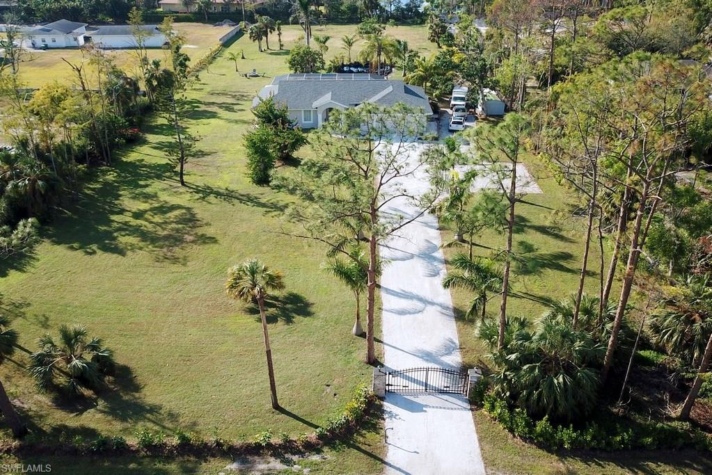 Logan Woods Estates Home on 2.25  beautifully cleared and landscaped acres. The recently remodeled and renovated 4 bedroom 2 bath home with a 2 car garage has a gorgeous 2000 square foot deck and heated pool overlooking a koi pond and water falls.  A new irrigation system was added to the property in 2017 as well as a new roof. The home has marble floors in the main living area and wood floors in the bedrooms.  It is an open floor plan with vaulted ceilings and fresh paint throughout. The modern kitchen has quartz countertops, a glass back splash and stainless steel appliances.  An auto entry gate welcomes you into this estate home with easy access from Pine Ridge Road and Logan Blvd yet the privacy and peace and quiet of the home is evident immediately.  This home provides easy access to all that is Naples. It is close to Exit 107 of I-75 and Physicians Regional Medical Center.  It is an easy drive to the white sand beaches of the Gulf of Mexico, Old Naples upscale shops and restaurants, the Botanical Gardens, Naples Zoo, The Artis, Mercato, Venetian Village and  many other points of interest. It is also a short drive to RSW; Fort Myers International Airport and Miramar Outlets.