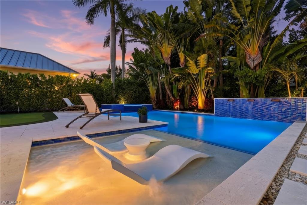 Introducing 725 Harbour Drive, ultimate luxury, situated in the iconic Naples beach community The Moorings. A modern coastal home designed by renowned architect, John Kukk this is a masterpiece you are sure to enjoy. It begins with an oversized corner lot allowing for a side entry three car garage. This component leaves the front of the home unencumbered with garages, providing a beautiful circle drive as you pull up to the impressive entry. Step inside on the white oak floors and soak in the entry way and living area offering views through the expansive back lanai via 10ft fully pocketing sliding glass doors. The west side of the home is your dedicated owner’s suite including a workspace, beautiful bathroom, large dual closets, a large bedroom including sitting area and private access outside to the pool and spa. The kitchen is a lovely combination of modern and classic with custom cabinetry and stone, a large walk-in pantry and a unique chopping block feature as a part of the large island where you will gather. The dining room is one of a kind with it’s 270 Degrees of windows. Upstairs you will find three ensuite bedrooms a massive bonus room atop the stairs and balconies that overlook the pool and putting green. Architecturally designed with an elevator shaft one can easily add this feature if needed. Outside in your private oasis you can relax on the pool sun deck, enjoy the spa, practice your putting, use the outdoor culinary space or simply turn on the fireplace and watch the game. With both storm shutters and screens it is a huge living space regardless the weather. This home’s base floor is at 12 ft elevation; flood waters have never been a concern. An easy stroll or bike ride to Venetian Village, Moorings Country Club, Moorings Private Beach Club and Naples amazing restaurants. What more can you ask for?