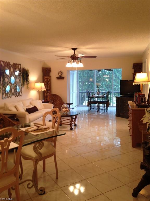 This is a 55+ community. This beautiful 2 bedroom 2 bath unit has been updated. Lanai is under air with triple sliders and wet bar. End unit with views of golf course, canal & pool. Unit is directly convenient to elevator. Covered parking is directly in front of unit, also 2nd covered parking in center area. This is a one of a kind, come and see.