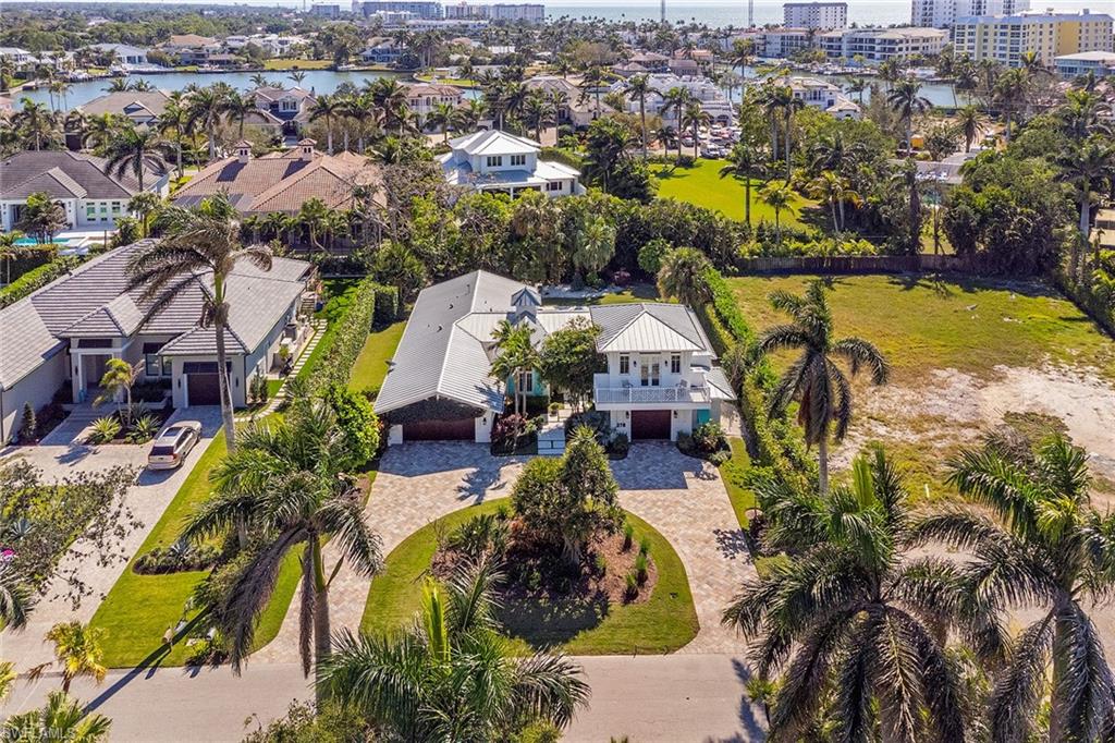 This beautifully updated four-bedroom home seamlessly combines coastal elegance with effortless comfort. Expansive windows flood the interior with natural light while providing serene views of the meticulously landscaped garden and sparkling pool, ensuring privacy and tranquility. The open-concept living area features raised ceilings and wood floors. The chef-inspired kitchen is a highlight, boasting luxurious quartzite countertops, a large central island and stainless steel appliances. Above the detached garage, a private cabana offers an ideal retreat. Complete with a full bath, cozy sitting area and breezy balcony, it's ideal for guests or as a home office. The lush, landscaped yard is an outdoor haven, offering a fenced backyard, an outdoor shower and vibrant plantings to enhance the serene atmosphere.