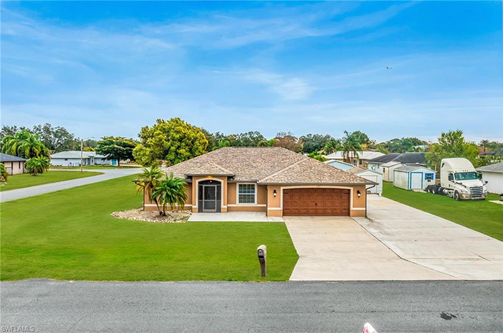 LUXURY CUSTOM UPGRADES, exceptional functionality, and true Florida living come together in this one-of-a-kind, move-in-ready POOL HOME situated on an OVERSIZED CORNER LOT. Thoughtfully updated from top to bottom, this property offers the perfect combination of style, quality, and peace of mind!

Major improvements include a newer roof, impact-resistant windows and sliding glass doors with built-in blinds, custom-built kitchen and bathroom cabinetry, updated flooring throughout, fresh interior and exterior paint, designer lighting, and a new garage door with a retractable screen. The home is also fully wired for security, high-speed internet, and outdoor speakers, making it as smart as it is beautiful.

The desirable split-bedroom floor plan offers both privacy and functionality. The spacious primary suite features private access to the pool, a walk-in closet, and an ensuite bath with dual vanities. Two guest bedrooms are tucked behind a pocket door, creating a private retreat for family and visitors.

Step outside to your own backyard oasis featuring a heated, screened-in pool, covered lanai, and convenient pool bath—perfect for entertaining or enjoying Southwest Florida's year-round sunshine.

A standout feature of this property is the oversized driveway and dedicated RV pad complete with electric and water hookups, providing parking for six or more vehicles plus a large RV — an incredibly rare find.

With high-end upgrades, abundant parking, and exceptional indoor and outdoor living spaces, this home is truly move-in ready and offers a lifestyle that's hard to match. Schedule your private showing today and experience everything this exceptional property has to offer.