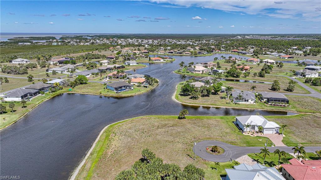 Rarely available, this exceptional double lot on Eagle Lake offers over 300 feet of pristine water frontage within the deed-restricted community of Burnt Store Lakes. Cleared and build-ready, this expansive homesite presents a unique opportunity to create a custom waterfront estate tailored to your vision. Ideally positioned on a quiet cul-de-sac, the property delivers a sense of privacy and tranquility while still being part of a vibrant, amenity-rich neighborhood. Public utilities, including city water and sewer, are already in place—streamlining the path to building your dream Florida retreat. Residents of Burnt Store Lakes enjoy a relaxed yet active lifestyle, with access to a community park, pavilion, and kayak launch, as well as miles of scenic sidewalks perfect for morning walks or evening strolls. Just minutes away is Burnt Store Marina the largest deep-water marina in Southwest Florida. This is a rare opportunity to secure an oversized waterfront parcel in one of the most desirable communities along the Burnt Store corridor—where natural beauty, recreation, and coastal living converge.