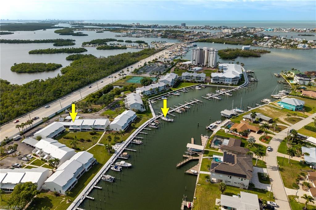Large Dock and Covered Parking Space are included. Come by Boat, Come by Car. Dock is located just steps from your Unit and Covered Parking is almost at your front entry door. Boardwalk Caper has always been dynamic community prized for its easy access to beaches, shopping and endless fun. Area's Best Deep Canal will take you to open waters of San Carlos Bay, Fort Myers Beach and the Gulf of America in just a few minutes. First Floor of this home has been fully upgraded, including storm rated sliders and appliances. You are short distance from a variety of restaurants and Estero Island's Times Square. Whether you enjoy fishing, boating, kayaking, paddleboarding, swimming, or just strolling the boardwalk watching for Dolphins, this home provides a great place to start your next Florida memories. Best Priced Home in Boardwalk Caper.