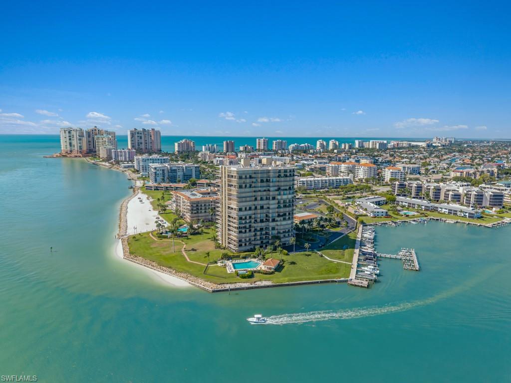 Experience some of the most breathtaking views on Marco Island from this exceptional 14th-floor corner residence at Shipps Landing. Perfectly positioned to capture unobstructed panoramas of Caxambas Pass, the Ten Thousand Islands, and the Gulf of Mexico, the views are truly the centerpiece of this remarkable condominium —stretching endlessly from every room and creating a constantly changing backdrop of sparkling water, passing yachts, playful dolphins, manatees, tropical birdlife, vibrant sunrises, and unforgettable sunsets. Encompassing more than 1,700 square feet of furnished living space, this spacious two-bedroom, two-bath residence lives like a private sky home, complemented by expansive lanais designed to fully embrace the extraordinary scenery from dawn to dusk. Boating is seamlessly integrated into the lifestyle, with a newly completed boat dock and additional docks available for lease, providing convenient access to the Gulf and the renowned waters surrounding Marco Island. Nestled within the prestigious 15-acre gated enclave at the island's southern tip, residents enjoy an impressive collection of resort-style amenities including three waterfront pools and spas, a state-of-the-art fitness center, clubhouse, tennis and pickleball courts, private beach access, kayak storage, and fishing pier. An exceptionally rare offering where world-class views, boating, and luxury coastal living converge.