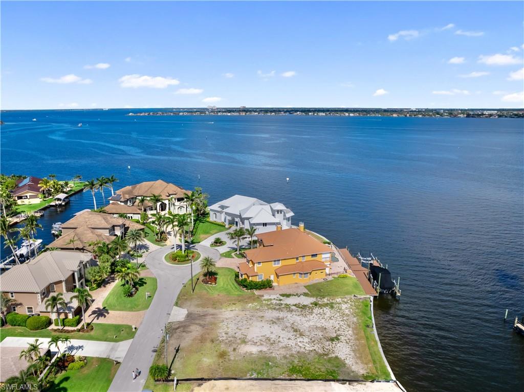 An extraordinary opportunity to build a custom waterfront estate in one of Southwest Florida’s most prestigious boating communities. Tucked away near the end of a quiet cul-de-sac in Town and River, this exceptional homesite offers a rare combination of protected deepwater dockage, direct Gulf access, and breathtaking views of the Caloosahatchee River.
With 106 feet of waterfront frontage and a brand-new seawall already completed, the property is perfectly positioned to accommodate a luxury waterfront residence designed around boating, entertaining, and elevated coastal living. The wide canal setting offers the privacy and protection discerning boaters value, while the rear exposure captures expansive river views and Southwest Florida’s unforgettable sunsets.
This is a setting that feels both private and grand — where yachts remain protected just moments from open water, yet every evening is framed by shimmering riverfront scenery.
Whether envisioned as a striking contemporary masterpiece or a timeless coastal estate, this homesite presents the opportunity to create something truly remarkable in one of Fort Myers’ most established luxury waterfront neighborhoods.
Properties offering this level of boating convenience paired with panoramic river views are exceptionally rare. In Town and River, opportunities like this are becoming increasingly difficult to find.
