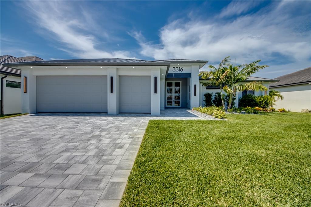 This stunning coastal designed waterfront residence in Cape Coral delivers the ultimate Southwest Florida lifestyle, combining custom architecture, luxury finishes, and effortless access to the Gulf. Designed for both entertaining and everyday comfort, the home features an expansive open floor plan anchored by a striking chef’s kitchen with a large waterfall island, custom cabinetry, and an impressive array of appliances with Cooktop and Built in Wall Over/Microwave. The living and dining areas flow seamlessly into the outdoor living space through expansive glass doors, creating a true indoor-outdoor experience. Step outside to a resort-style lanai designed for year-round enjoyment. The spacious covered porch overlooks the pool and heated spa, while the full length lanai provides plenty of space to make hosting effortless. A paver captains walk creates the perfect setting for relaxing evenings along the water. Topping off the exterior, the home comes with a Standing Seam Metal Roof, Insulated Impact Garage Doors and a 10' Entry Door with Impact glass!  Inside, the home offers a thoughtfully designed layout with 4 Bedrooms, 3 Full Baths, elegant dining space, and a luxurious primary suite featuring a spa-inspired bathroom and expansive custom closet. Additional guest accommodations provide comfort and privacy for visitors. The oversized garage with epoxy flooring offers both durability and a high end finish. Situated on a Gulf-access canal, this exceptional property places boating, waterfront sunsets, and the best of the Cape Coral lifestyle right at your doorstep. This is coastal luxury at its finest.