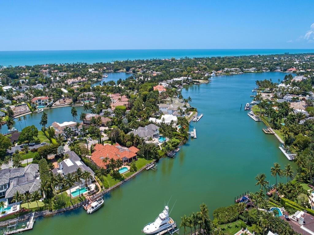 Stunning Port Royal residence on 1.5 lots with expansive 173 feet of waterfront footage. Large, welcoming gathering spaces with plenty of natural light.  Over 6,600 square feet under air and 9,000 square feet total area.  Spacious screened lanai, infinity pool and spa.  Dock with lift.  Superb finishes throughout.  Exceptional home for enjoying the best in gracious living today or creating your own new custom build.  Raised elevation.  Immediate Port Royal Club membership eligibility.  An outstanding opportunity.