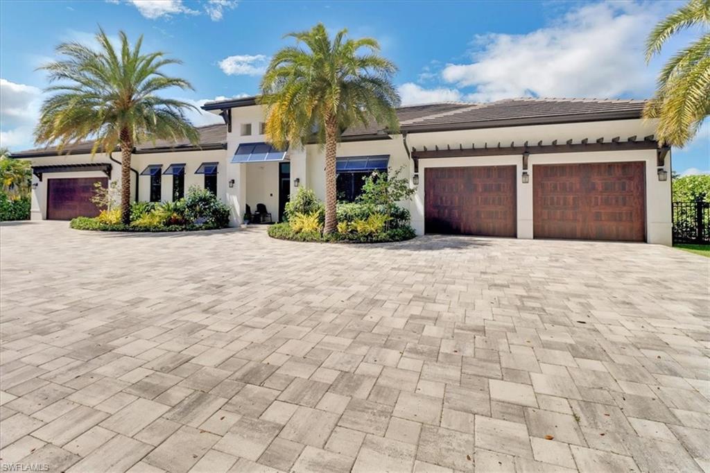 Do you love the beach and boating? This home offers both! Just a block from Lowdermilk Beach Park gives this home the ideal location. This 2020 waterfront home with new dock and seawall built in 2018 is worth seeing in person. Featuring 5 bedrooms and 6 baths all on one floor. Kitchen is up to date with the Thermador Masterpiece appliance package, wet bar has two True Residential Beverage and Wine refrigerators with a Uline nugget ice maker. Primary bedroom with a spa-like bathroom offers an amazing walk-in closet with another full size washer and dryer. The cabana bedroom has a separate entrance off pool/lanai with a dual sink ensuite. An outdoor kitchen with family area, resort style pool that overlooks the bay. Solar panels are 21.8 kWp peak power Solar Edge System, solar pool heater and Tesla Power walls- 4 power walls; each power wall can provide 5 kW of continuous power in case of power outage. Allini 1200 series whole house water filtration system. SONOS sound system prewired throughout home with full house security system with multiple cameras. Anderson impact windows and Lanai screens with hurricane electric shutters. The attic is sprayed with closed cell insulation. There are three 2- SEER A/C units. The Dock features two boat lifts: 32000 lb capacity and 10000 lb capacity, plus dual wave runner lift: 7000 lb capacity. Welcoming front electric gates completes this outstanding home with the best sunset view in Naples!