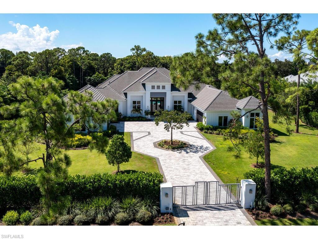 Stunning Coastal Contemporary home located in Naples’ most sought after community of Pine Ridge Estates - Features great room concept with 4 oversize en-suite bedrooms & 5 ½ baths, large office & bonus room with 132-inch projection screen. 4 en-suite bedrooms feature custom walk-in closets, ceiling detail & electric window treatments. Master suite features vaulted ceilings, sitting room, morning bar & custom designed his/her closets. 
Gourmet kitchen boasts a 16-foot center island, quartz & marble countertops, Miele appliances including coffee system, 2 dishwashers, gas range, wine cooler, 2 ovens, & walk-in pantry. Control 4 smart-home system controls all Lighting, Sound, HVAC, Window Treatments, Electronic Gates & Home Security system with 17 exterior cameras. 50-KW Whole-home generator including 1000-gallon propane tank ensures continuous operation of all features.
Expansive resort-style outdoor living area is perfect for entertaining, and offers panoramic views of the park-like setting of this 1.69 acre estate. Features multiple sitting areas, outdoor kitchen with bar, fireplace, outdoor fire-pit, large pool & spa with fire/water features, colored led lighting & sun shelf.