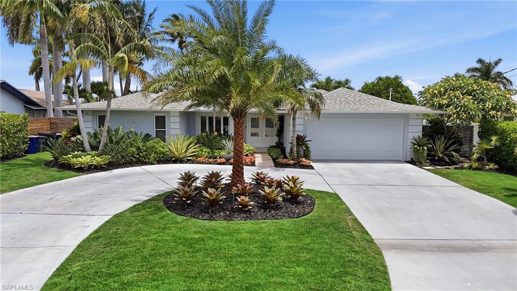 Beautifully remodeled 4-bedroom, 2-bath waterfront residence offering the ultimate Florida boating lifestyle with direct Gulf access in the highly sought after Mcgregor Isles. Designed for both everyday living and effortless entertaining, this exceptional home has been thoughtfully updated and maintained with meticulous attention to detail. Step inside to an open-concept floor plan featuring Cortec luxury vinyl flooring and tile throughout. The stunning chef's kitchen is the heart of the home, showcasing elegant quartz countertops, an oversized island, stainless steel appliances, a beverage refrigerator, abundant cabinetry, and a spacious layout that flows seamlessly into the living and dining areas.The primary suite features a custom built-in storage system and a custom closet by California Closets. The spa-inspired primary bath offers a soaking tub and separate shower with dual shower heads. Outdoor living is equally impressive with an oversized screened lanai that extends your living space and provides the perfect setting for relaxing or entertaining while overlooking the tranquil canal. The professionally-designed tropical landscaping creates a private resort-like atmosphere, enhancing the home's exceptional curb appeal and is equipped with an automatic irrigation system on a private well. Boaters will appreciate the waterfront amenities, including direct Gulf access, 2 boat lifts (10,000lb AND a 7,500lb), and a dedicated exterior storage area for fishing and boating gear. The fully renovated garage features epoxy flooring and custom shelving. Additional updates and features include hurricane shutters, a whole-home water filtration system, a new water heater, a new washer and dryer, a whole-home security system, and the peace of mind that the home has NEVER FLOODED during any storms. This move-in ready waterfront gem combines luxury, functionality, and an unbeatable boating location in the heart of Ft Myers, making it the perfect place to enjoy the very best of Southwest Florida waterfront living.