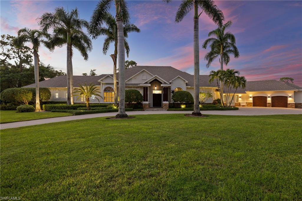 Impossible to replicate at this price!  PRICED BELOW APPRAISED VALUE! Completely reimagined and renovated by BCB Homes, this exceptional 1.3-acre corner lakefront estate in Pine Ridge captures coveted western exposure and spectacular sunset views across the water. A comprehensive 2020 renovation introduced wide-plank engineered hardwood flooring throughout, beautifully redesigned bathrooms, and numerous high-quality upgrades that reflect thoughtful design and superior craftsmanship. The interior blends timeless architecture with modern luxury, highlighted by soaring volume ceilings, a striking fireplace, art lighting, and a 300+ bottle temperature-controlled wine cellar. The gourmet kitchen features premium appliances and generous space for both daily living and elegant entertaining.

The flexible floor plan offers outstanding versatility, including a dedicated exercise room, a private loft suite with sitting area—ideal for an au pair or extended guests, and a second primary suite with morning bar, perfect for hosting family and friends in complete comfort.

Surrounded by lush, professionally landscaped grounds, the property offers exceptional privacy and tranquility on one of Pine Ridge’s most desirable lakefront corner parcels. Additional features include a circular driveway, oversized 3-car garage with potential expansion to a 6+-car garage, whole-house generator, large air-conditioned storage area, and a dedicated dog room. Located in X-Zone (no flood insurance required), this is a rare opportunity to own a private lakefront estate in one of Naples’ most sought-after neighborhoods. A truly special Pine Ridge offering combining acreage, privacy, sunset views, and quality craftsmanship