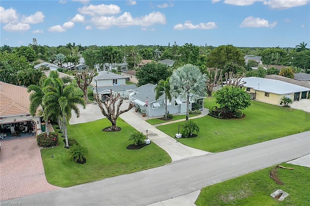 ULTRA-RARE find in Naples Park! Interior pictures coming soon! This single family home w/ a BRAND NEW ROOF is situated on just under half an acre - which is one of the last few oversized lots in all of Naples Park. Great location- only minutes from the Gulf of Mexico, just a short drive to the world famous shopping/dining of 5th Avenue, surrounded by custom built single family homes, and only a few blocks away from all the conveniences of life that line Tamiami Trail. The home was built in 1961 and then in 1984 the garage was added giving you covered parking and lots of storage. Meticulously maintained yard filled with mature tropical landscaping giving you your own slice of paradise that has endless options.