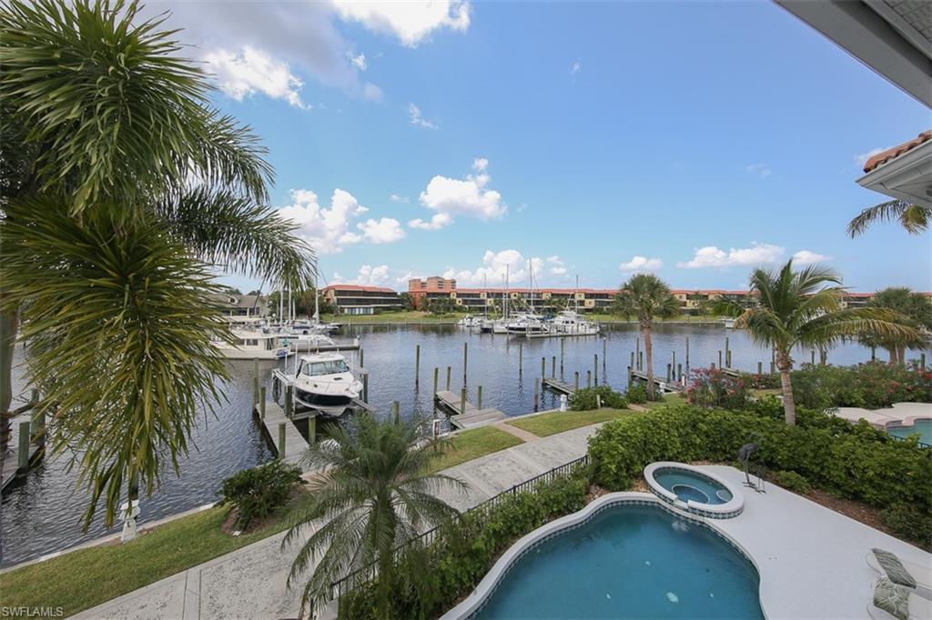 Come experience the epitome of marina-front living from this well cared for, turnkey furnished, 2 story beauty on Burnt Store's south basin! This impeccably maintained 3BR home boasts 2 master suites (one on each floor) & offers phenomenal upgrades! The handsome gourmet kitchen is truly an entertainers dream. Custom built cabinetry is showcased with tasteful moldings & under mount lighting. Quality stainless appliances are nice additions for this work space.The inviting eat-in nook enjoys pleasant courtyard views, while comfortable bar seating is available to keep the cook company. If you prefer to entertain outdoors, the attractive lanai is the place for you. Slide open the glass doors in the dramatic 2 story great room & enjoy the handsome summer kitchen! Fabulous diamond set tile floor extends out from the main living space & is surrounded by a handsome listello border. The handy wet bar is finished w/marine grade cabinetry, solid surface tops & a stainless wine chiller. Step out to the pool deck & bask in the southern sun while you enjoy your favorite beverage as you watch the boats enter the main basin right behind your home!