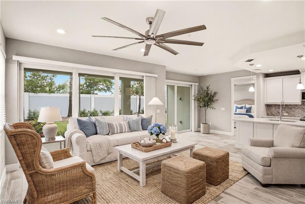 One or more photo(s) has been virtually staged, AI generated or rendered.  2024-BUILT, COASTAL CONTEMPORARY, GROUND-FLOOR “END UNIT” WITH SOUTH EXPOSURE FOR GORGEOUS NATURAL LIGHT & SUNSETS! Features an OPEN-CONCEPT FLOOR PLAN with 2 bedrooms, 2 bathrooms, ATTACHED 1-CAR GARAGE, HURRICANE IMPACT WINDOWS & SLIDERS, TILE ROOF, DRIFTWOOD-STYLE TILE FLOORING throughout the main living areas, NEW CARPET (2026), and large sliding glass doors that fill the home with natural light. Located in the GATED COMMUNITY OF SEYCHELLES, ideally located in a prime Naples location just a short drive from the PRISTINE GULF BEACHES and the world-renowned FIFTH AVENUE SOUTH with its exceptional dining, shopping, and entertainment. Step outside to your LARGE PRIVATE SCREENED LANAI, where you'll enjoy peaceful landscaped views, SOUTHERN EXPOSURE, and a private yard area—creating the perfect setting for relaxing, dining, or entertaining outdoors. The spacious living and dining areas flow seamlessly into the beautifully appointed chef's kitchen, featuring QUARTZ COUNTERTOPS, white cabinetry, and a tile backsplash. The generous primary suite offers a LARGE WALK-IN CLOSET and an ensuite bath with dual vanities and a frameless glass walk-in shower. A desirable SPLIT-BEDROOM FLOOR PLAN provides privacy for guests, complemented by a full guest bath and a convenient laundry room. Residents of Seychelles enjoy an array of RESORT-STYLE AMENITIES, including a 4,500-SQUARE-FOOT CLUBHOUSE, HEATED POOL & SPA, FITNESS CENTER, GATED ENTRY, and outdoor gathering spaces. Conveniently located with easy access to NAPLES BEACHES, FIFTH AVENUE SOUTH, I-75, and SOUTHWEST FLORIDA INTERNATIONAL AIRPORT, this home offers the perfect blend of luxury, convenience, and low-maintenance living—ideal as a full-time residence, seasonal getaway, or investment opportunity.