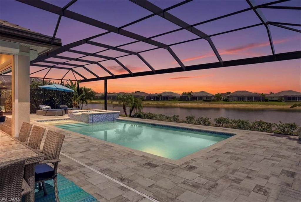 Thoughtfully upgraded and meticulously maintained, this Stock Development residence offers over 3,100 square feet of living space, a desirable waterfront setting and a level of functionality rarely found in comparable homes. Featuring 4 bedrooms, a private den, 3.5 baths and a three-car garage, the home was designed to balance spacious living with everyday comfort.

At the heart of the home is a chef-inspired kitchen appointed with quartz countertops, custom cabinetry, premium appliances and a gas cooktop. The open-concept floor plan flows effortlessly between the kitchen, dining area and great room, creating an inviting space for both entertaining and daily living. Expansive sliding glass doors blur the line between indoors and out, embracing Southwest Florida's signature lifestyle.

The private primary suite offers a peaceful retreat, while three additional guest bedrooms and a dedicated den provide flexibility for family, visitors or a home office. Impact-resistant windows and doors, a fully climate-controlled three-car garage and storage area with a dedicated mini-split system, a whole-house generator, and numerous thoughtful upgrades throughout provide comfort, convenience and peace of mind.

Outdoor living is equally impressive. A custom pool and spa, expansive screened lanai and fully equipped outdoor kitchen create the perfect setting for relaxing or entertaining. The home's propane system services the outdoor kitchen, gas cooktop, pool heater and whole-house generator, delivering functionality and efficiency rarely found in comparable properties. The waterfront homesite offers tranquil water views and is connected to Naples Reserve's signature lake system, enhancing both the setting and lifestyle.

Residents of Naples Reserve enjoy an exceptional amenity package centered around a waterfront lifestyle, including a lakeside clubhouse, resort-style pool, fitness center, pickleball, tennis, bocce, tiki bar, private island, boat launch, walking trails and miles of interconnected lakes.

Combining the quality of Stock Development construction, extensive upgrades, generous living space and one of Naples Reserve's most sought-after lifestyles, this exceptional residence is ready to be enjoyed from day one.