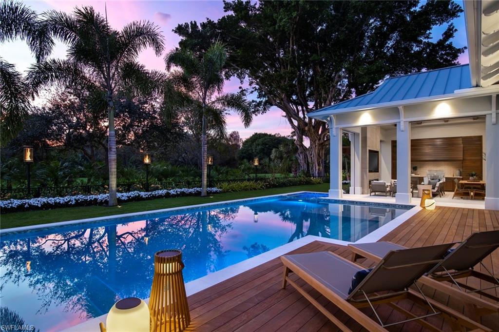 Introducing this season’s gorgeous new coastal chic estate home by Calusa Bay. With sweeping golf course views, artful design, and expert craftsmanship, it’s simply the best home of the season in the highly coveted ocean front community of Pelican Bay. Custom designer details astonish from the moment you enter the home. Floor-to-ceiling glass doors and windows flood the single level home with natural light, accenting the wide plank Italian oak floors that run throughout. Details like the glass wine room and the chef’s kitchen with a 24’ folding glass wall opening onto the outdoor great room make this home an entertaining dream come true. Residents will enjoy 4 spacious en suite bedrooms, an indoor and outdoor great room, chef’s kitchen, outdoor kitchen, butler’s pantry, office/clubroom, 3 car garage, 50 foot saltwater pool with spa and outdoor shower. Brought to you by the dream team of Stofft Cooney Architects, Knauf Koenig Group, and Calusa Bay Interior Design, it is surely this season's most stylish and sought-after new residence. Situated on a quiet cul-de-sac in Pelican Bay, moments from Waterside, Artis Naples, Mercato, and a short distance to the private beach amenities.