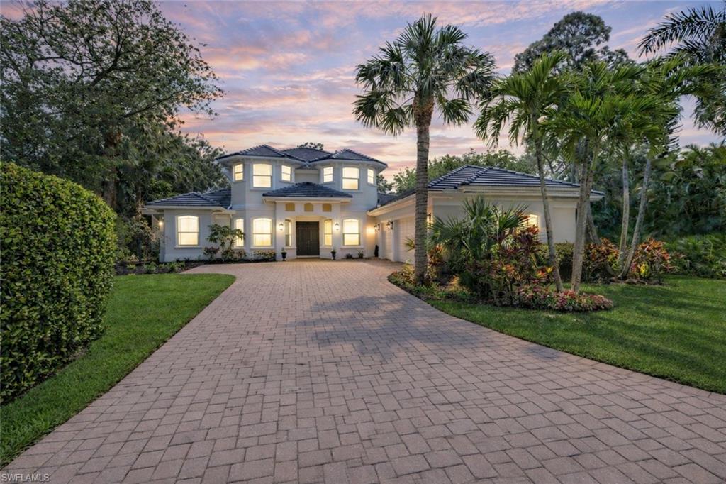 Freshly remodeled and move-in ready, this beautifully updated estate showcases a stunning transformation with all-new whitewashed tile flooring, a completely renovated spa-inspired primary bathroom featuring a freestanding porcelain soaking tub, an extensively updated first floor, elegant white quartz countertops, fresh landscaping and sod, and an expansive backyard ideal for children, pets, and outdoor living. Welcome to this meticulously maintained 4-bedroom plus study and bonus room residence situated on over a half-acre in the highly sought-after, centrally located community of Hawksridge. Nestled on a quiet cul-de-sac and surrounded by mature trees, lush tropical landscaping, and a peaceful pond with a water feature, this property offers exceptional privacy, space, and timeless appeal just minutes from Naples beaches, 5th Avenue South, Waterside Shops, Mercato, and top-rated schools. Offering over 4,000 square feet of living space, the flexible floor plan features a dramatic two-story living room with soaring vaulted tray ceilings, a newly recarpeted curved staircase, and a natural stone fireplace. Additional living spaces include a custom billiards/game room and a private study, creating the perfect setting for both entertaining and everyday living. The bright coastal-inspired kitchen features white cabinetry, granite countertops, stainless steel appliances, and an open-concept design that seamlessly connects to the main living areas. The first-floor primary suite serves as a private retreat with tray ceilings and an adjoining flex space ideal for a second office, nursery, fitness room, or sitting area. Upstairs, a spacious media and bonus room provides additional versatility for family and guests. Recent improvements include hurricane-impact windows on the upper level, a newer roof, fresh interior and exterior paint, and extensive renovations throughout, creating a crisp, modern aesthetic while maintaining the home's warmth and character. Outdoor living is equally impressive, featuring a large covered lanai, full outdoor kitchen, oversized pool and spa with cascading water features and AquaLink automation, and a massive fenced backyard rarely found in such a central Naples location. Additional highlights include an oversized three-car garage with ample storage space. Hawksridge is a low-density, gated community known for its mature landscaping, tennis courts, clubhouse, and premier location near downtown Naples, world-class shopping and dining, pristine Gulf beaches, and A-rated schools. This exceptional residence offers a rare combination of space, privacy, extensive upgrades, and an unbeatable Naples location. One or more photos have been virtually staged, AI-generated, or rendered.