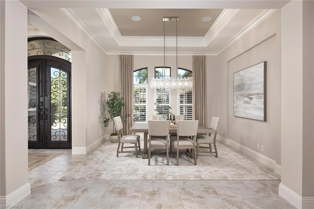 Designed for the Florida lifestyle, the home’s indoor spaces open effortlessly to a resort-style outdoor oasis featuring a newly updated pool and spa, outdoor kitchen, and covered sitting area, perfect for entertaining or quiet relaxation. Exquisite former model home in The Colony where sophisticated design meets modern comfort.
Step through a stunning wrought iron entry into this impeccably designed former model home, offering 3 spacious bedrooms, 3 full bathrooms, a generous 3-car garage, and a versatile bonus room ideal for a den, media space, or guest suite. Built in 2015—making it one of the newest single-family homes in The Colony—this residence seamlessly blends timeless elegance with today’s luxury lifestyle. Thoughtful architectural details abound, from custom ceiling treatments to beautifully laid tile flooring that flows throughout the main living spaces. The open-concept floor plan is ideal for both entertaining and everyday living, with the heart of the home centered around a chef-inspired kitchen featuring gorgeous quartzite countertops, gas cooking, top-tier appliances, and a walk-in pantry designed to impress even the most discerning culinary enthusiast. Retreat to the expansive primary suite with dual walk-in closets and a spa-like bathroom complete with a soaking tub, separate shower, and elevated finishes. Two additional guest suites offer privacy and comfort for family and friends alike. The bonus room—with direct pool access and custom built-in cabinetry—offers incredible flexibility to suit your lifestyle.  Additional highlights include impact-rated windows and doors for peace of mind and energy efficiency. This is a rare opportunity to own a newer, meticulously updated home in the sought-after Colony community—where elegance, comfort, and lifestyle converge. The Colony Golf & Bay Club is a highly amenitized community to include a private island beach park, private dining at The Bay Club, fitness center, tennis, pickle ball, kayaking & sailing. Golf memberships optional. The community is situated in a highly sought after area of Southwest Florida, just minutes to the Intl. airport; super close to shopping and dining.