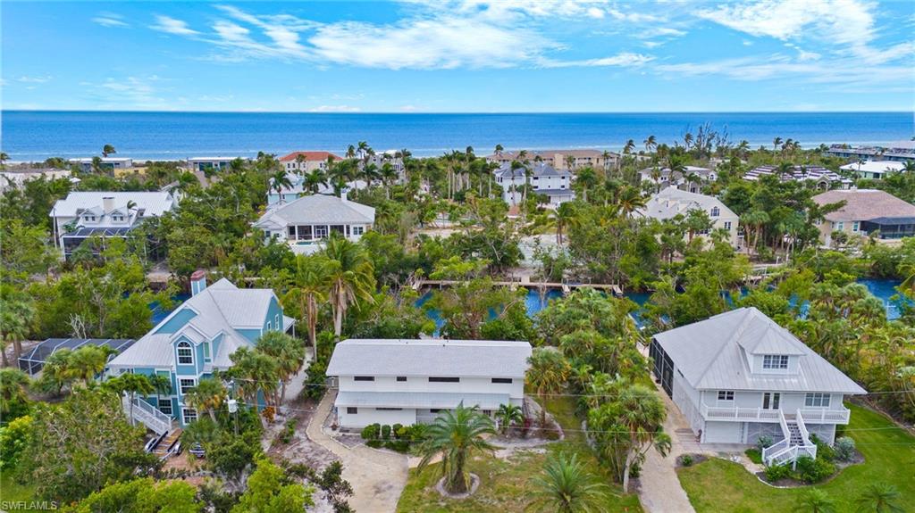 On Sanibel's desirable east end is this wonderful south-facing home on a wide navigable canal. Enjoy beautiful views of your large, private backyard and pool, perfect for get-togethers and cookouts, out to your private dock and the beautiful tropical canal beyond. Untie your boat for the short ride to the bay and Gulf for a day of island hopping or fishing, or slide a kayak or paddle board into the blue waters and enjoy the surrounding natural beauty of the east-end canal system. Sanibel's east end is also convenient to shops, restaurants and just a short bike ride to Sanibel's award-winning beaches. Miles of bike paths are just out of your back door and your day's adventure has many enticing options. This two-story home boasts over 2,500 square feet of living area with a charming and inviting feel. The top floor features the primary bedroom, and a guest bedroom, and laundry room. The spacious first floor features charming beamed ceilings and a wonderful feel. The home incurred water intrusion from the storm and has been remediated down to the studs on the first floor only. This is the perfect opportunity to put your personal touch in finishing off this stunning canal home.