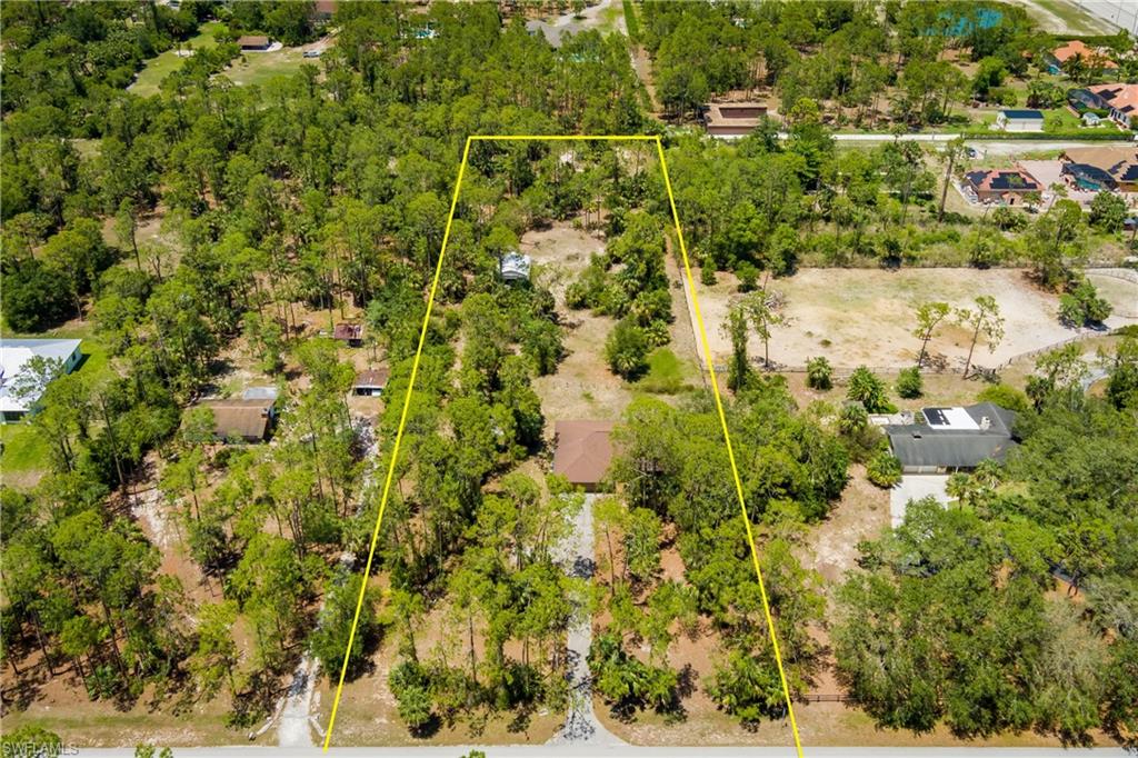 West of Collier Blvd!! 2.73 acres of prime real estate!! The property has plenty of width and depth to provide many opportunities!! The property has a 25 by 28 (725 sq ft) and 14 ft high metal detached garage/workshop with concrete flooring in the back of the property that was installed in 2012!! No wetlands on the property! Conveniently located a quarter mile south of Vanderbilt Road!! Grocery store, gas station and many of the essential stores are only 3 minutes away!! The home/property is nestled back far enough away from the hustle and bustle of city life, yet, still close to the essential stores!! The roof was replaced on the home in 2018!!