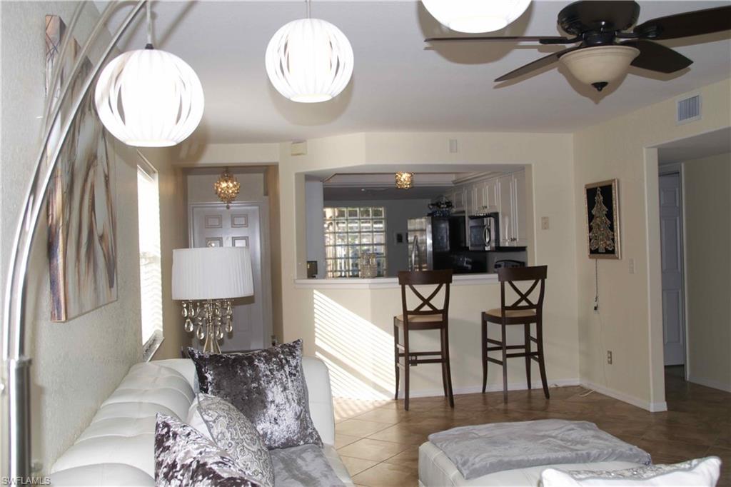 Make this cozy 2/2 your escape from the cold or full time residence.  Light and bright first floor end unit at The Manor at Morton Grove has been impeccably maintained.  Tile throughout, walk out screened lanai  to landscaped area. Two bedrooms, two full baths, large master closet and additional storage. Newer A/C, covered carport, community pool and clubhouse.  Centrally located in Bonita Springs, minutes to beaches, shopping, dining, YMCA, SWFL International airport, Naples and the new Bonita Springs Downtown Development District.   Move in ready, furnishings negotiable.